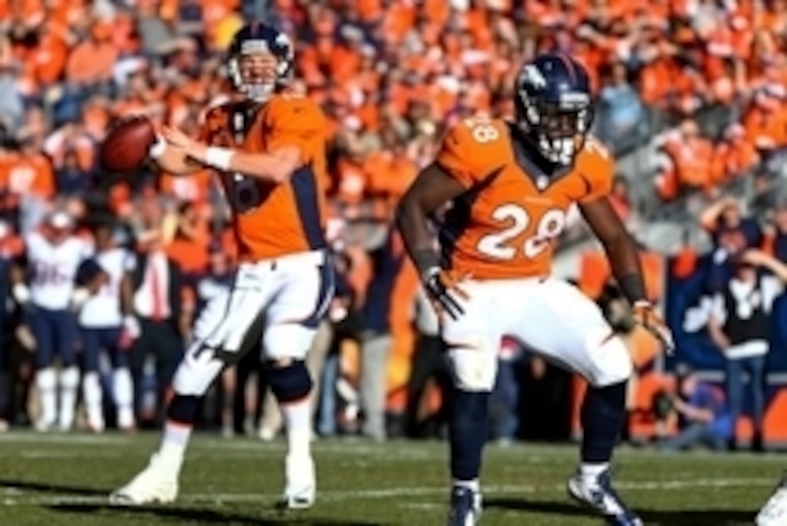 Jan 19, 2014; Denver, CO, USA; Denver Broncos running back Montee Ball (28) blocks for quarterback Peyton Manning (18) against the New England Patriots during the 2013 AFC Championship football game at Sports Authority Field at Mile High. Mandatory Credit