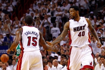 MIAMI, FL - JUNE 09:  (R-L) Udonis Haslem #40 gives teammate Mario Chalmers #15 of the Miami Heat a five in the first quarter while taking on the Boston Celtics in Game Seven of the Eastern Conference Finals in the 2012 NBA Playoffs on June 9, 2012 at Ame