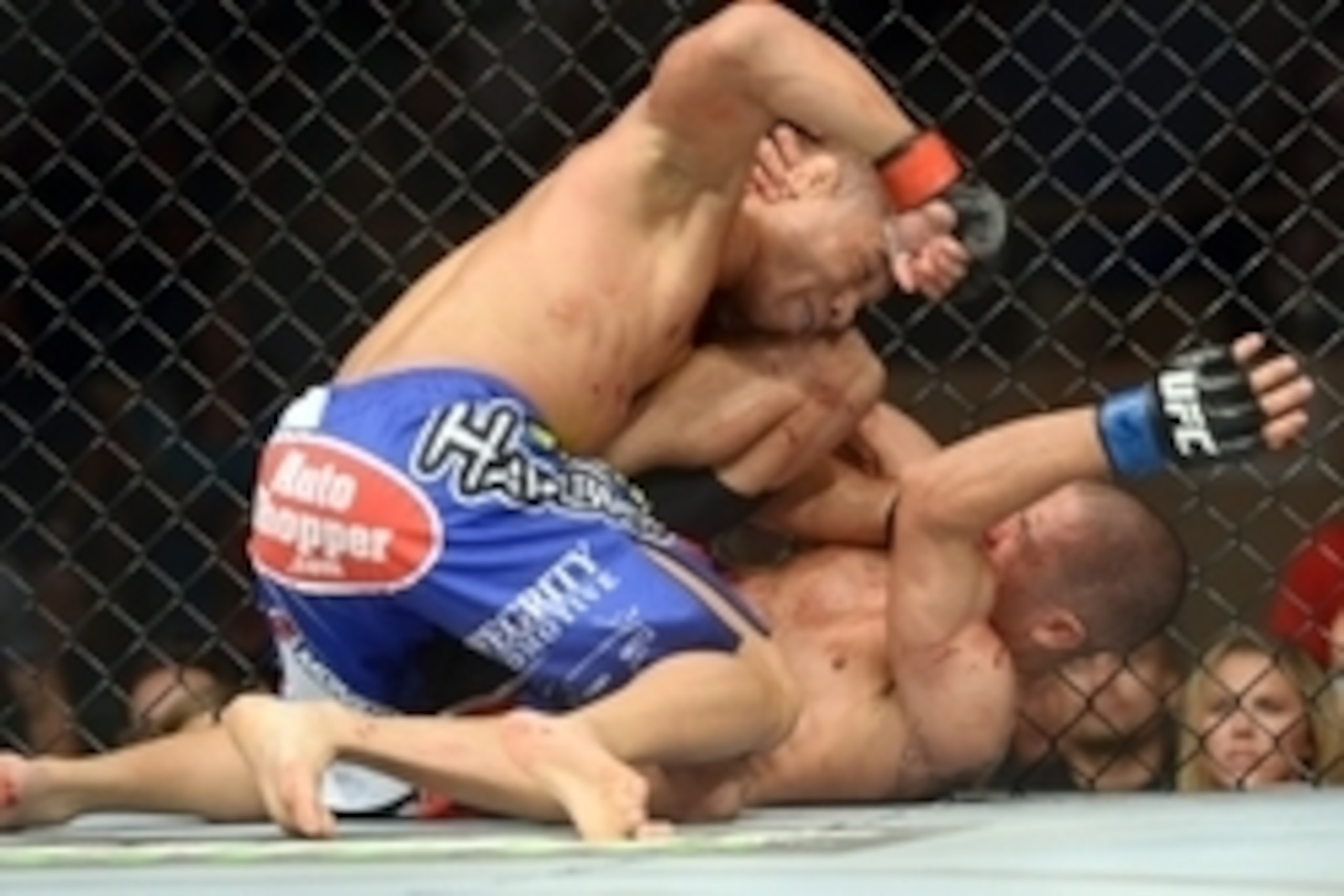 Jun 7, 2014; Albuquerque, NM, USA; John Dodson (red) and John Moraga (blue) fight during their flyweight bout during UFC Fight Night 42 at Tingley Coliseum. Dodson won after a doctor's stoppage at the end of round two. Mandatory Credit: Joe Camporeale-USA