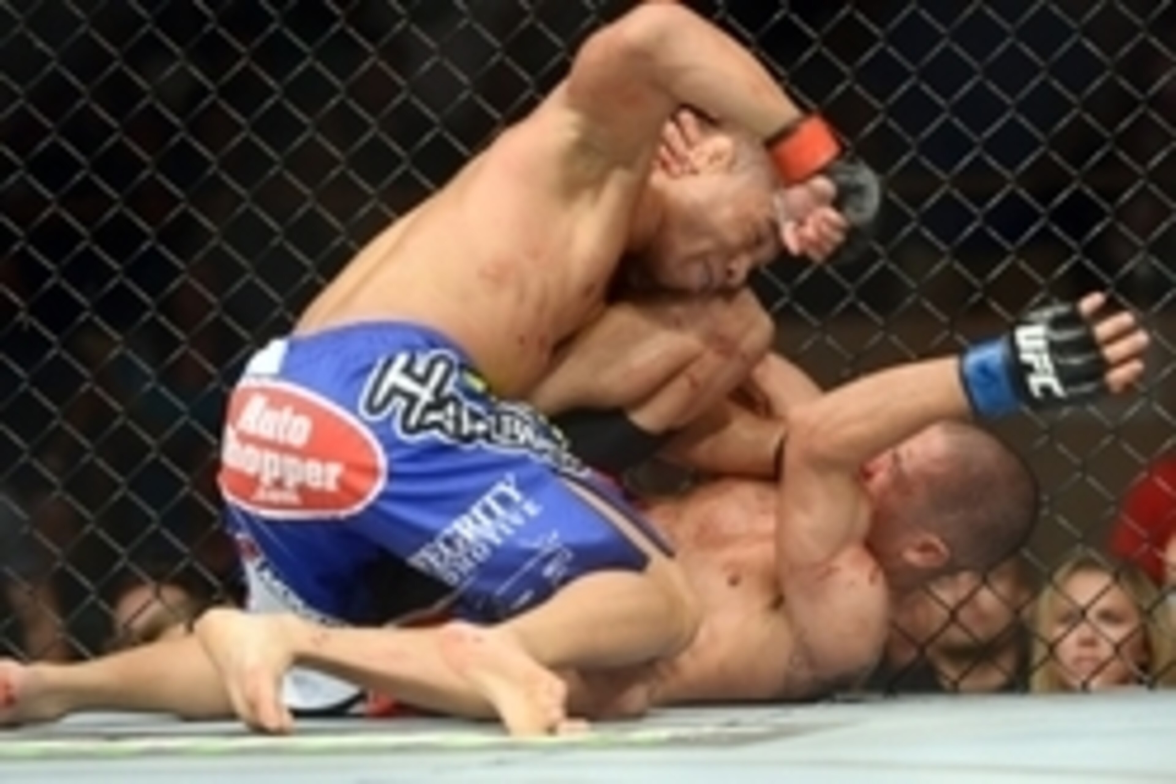 Jun 7, 2014; Albuquerque, NM, USA; John Dodson (red) and John Moraga (blue) fight during their flyweight bout during UFC Fight Night 42 at Tingley Coliseum. Dodson won after a doctor's stoppage at the end of round two. Mandatory Credit: Joe Camporeale-USA