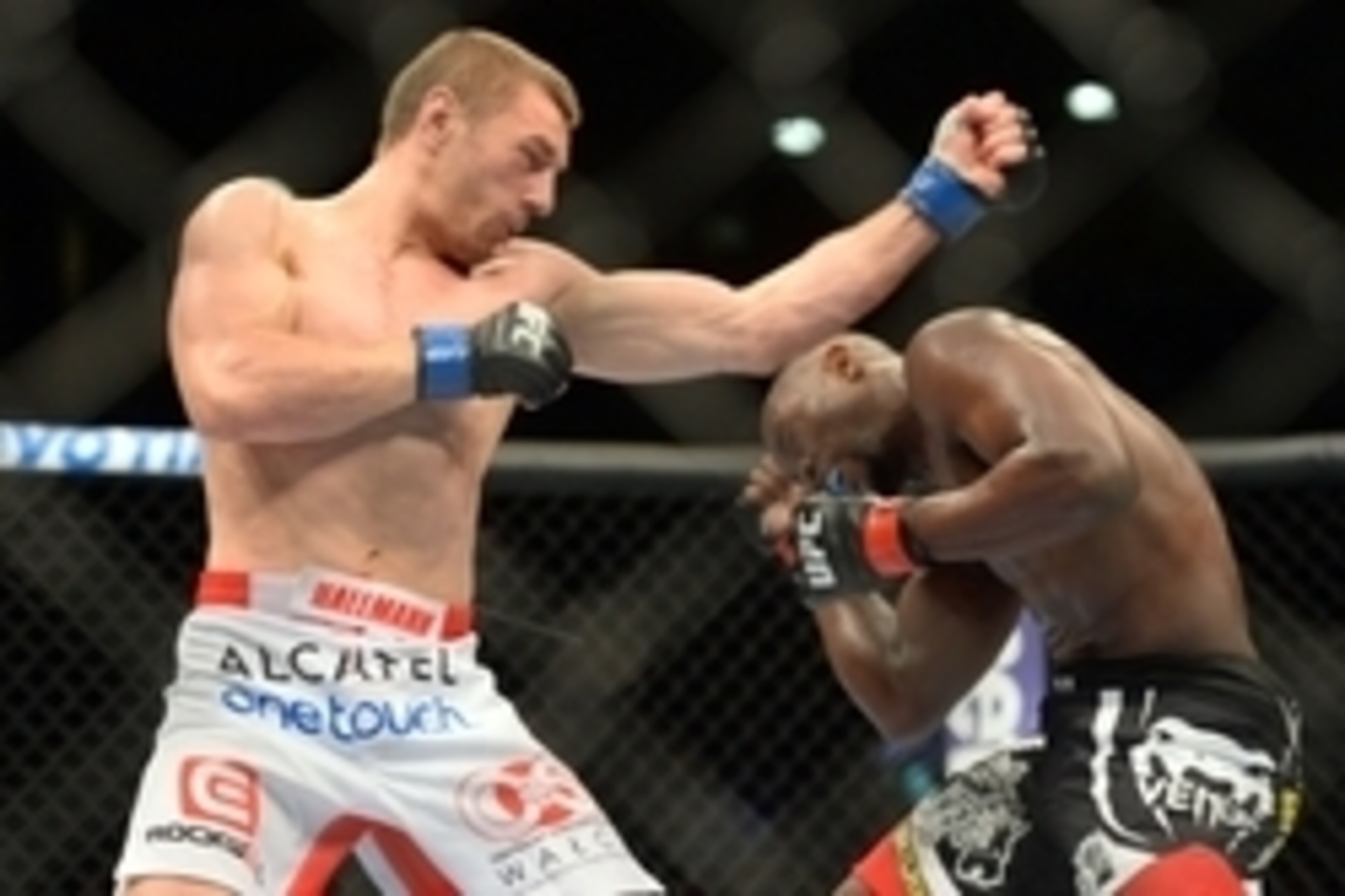 Jun 7, 2014; Albuquerque, NM, USA; Yves Edwards (red) and Piotr Hallmann (blue) fight during their lightweight bout during UFC Fight Night 42 at Tingley Coliseum. Hallmann won via third round submission. Mandatory Credit: Joe Camporeale-USA TODAY Sports