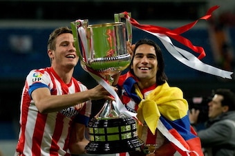 MADRID, SPAIN - MAY 17:  Radamel Falcao (R) of Atletico de Madrid holds the trophy in celebration with his teammate Saul during the Copa del Rey Final match between Real Madrid CF and Club Atletico de Madrid at Estadio Santiago Bernabeu on May 17, 2013 in
