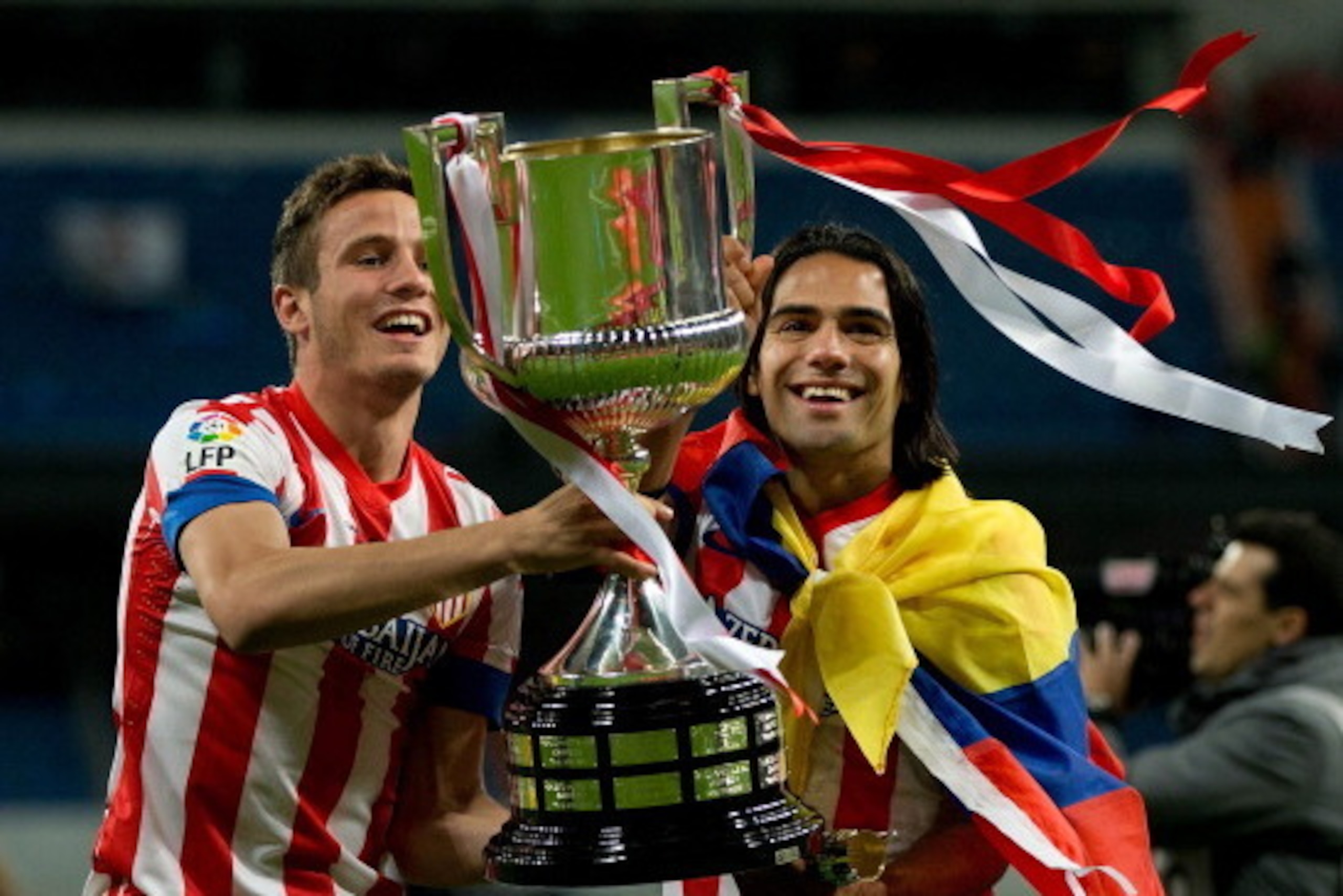 MADRID, SPAIN - MAY 17:  Radamel Falcao (R) of Atletico de Madrid holds the trophy in celebration with his teammate Saul during the Copa del Rey Final match between Real Madrid CF and Club Atletico de Madrid at Estadio Santiago Bernabeu on May 17, 2013 in