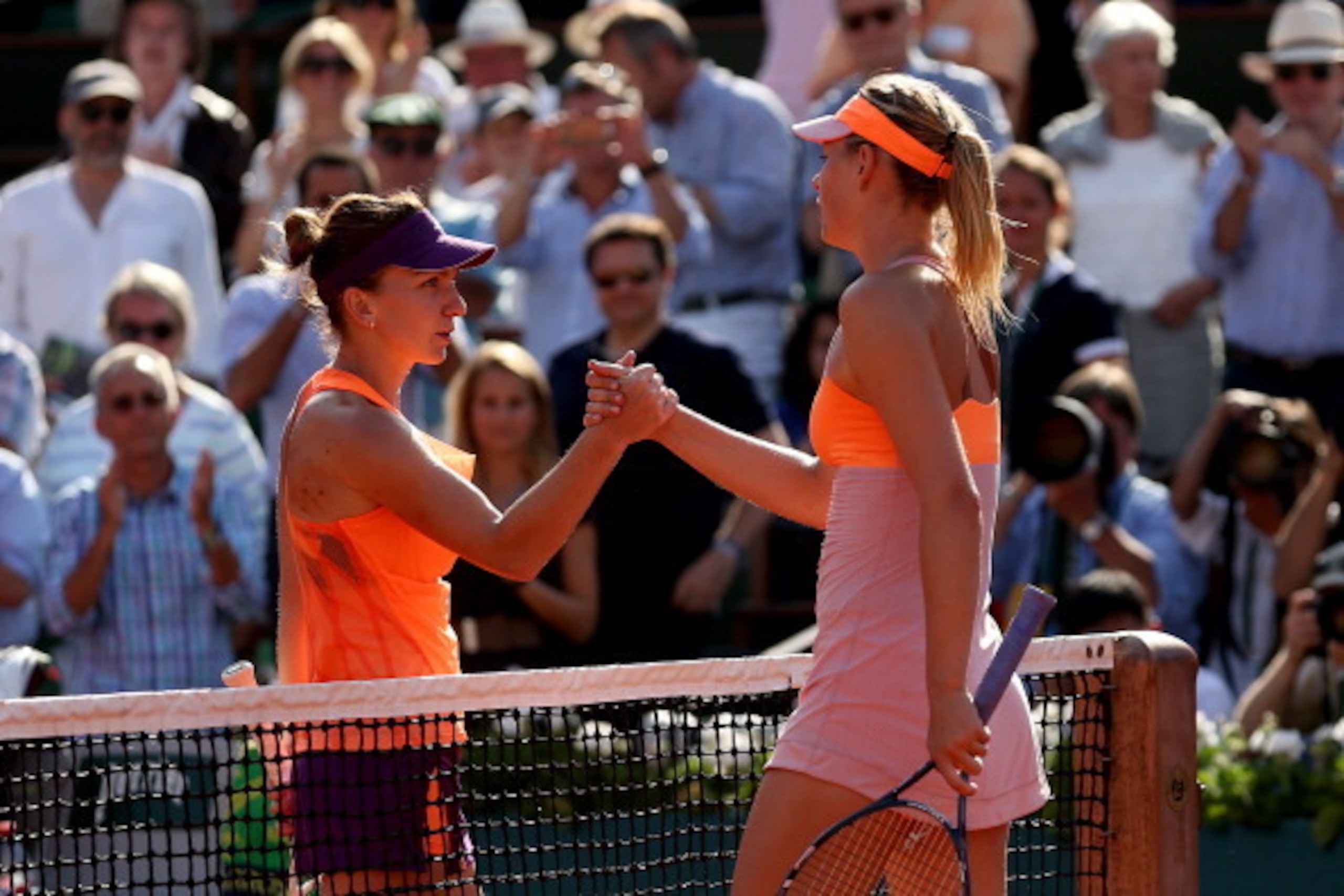 PARIS, FRANCE - JUNE 07:  Simona Halep of Romania shakes hands with Maria Sharapova of Russia after their women's singles final match on day fourteen of the French Open at Roland Garros on June 7, 2014 in Paris, France.  (Photo by Matthew Stockman/Getty I