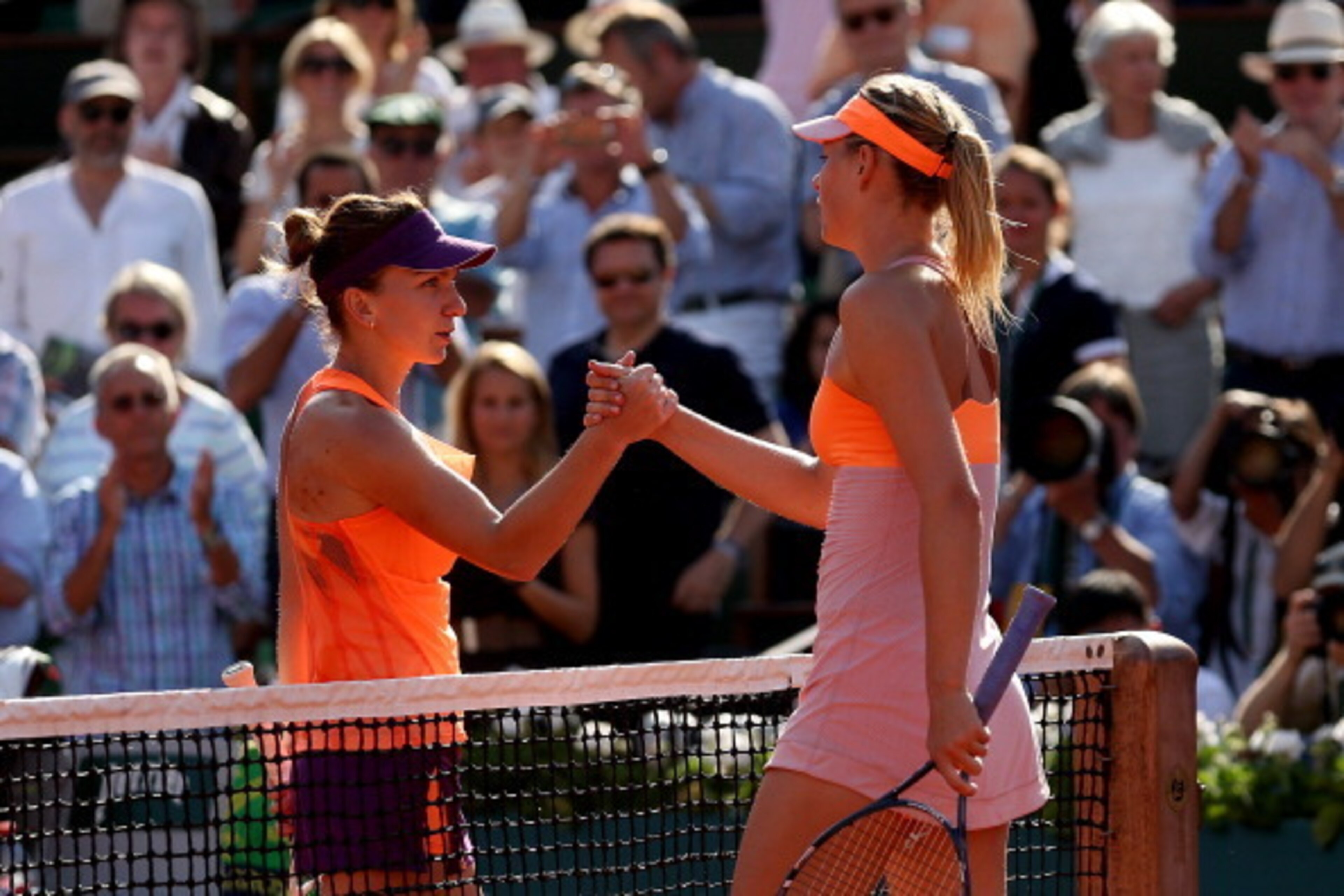PARIS, FRANCE - JUNE 07:  Simona Halep of Romania shakes hands with Maria Sharapova of Russia after their women's singles final match on day fourteen of the French Open at Roland Garros on June 7, 2014 in Paris, France.  (Photo by Matthew Stockman/Getty I