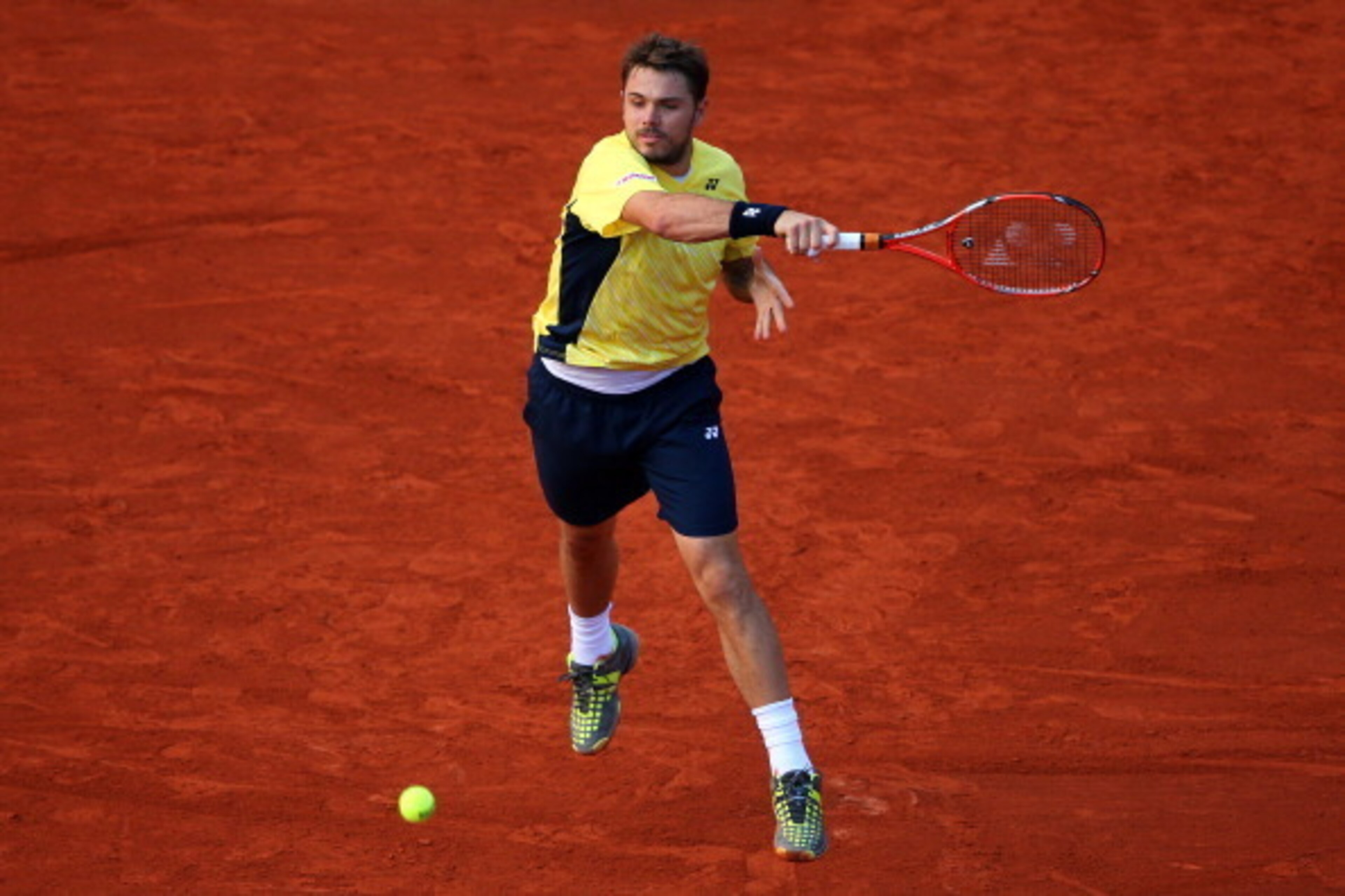 PARIS, FRANCE - MAY 26:  Stanislas Wawrinka of Switzerland returns a shot during his men's singles match against Guillermo Garcia-Lopez of Spain on day two of the French Open at Roland Garros on May 26, 2014 in Paris, France.  (Photo by Clive Brunskill/Ge
