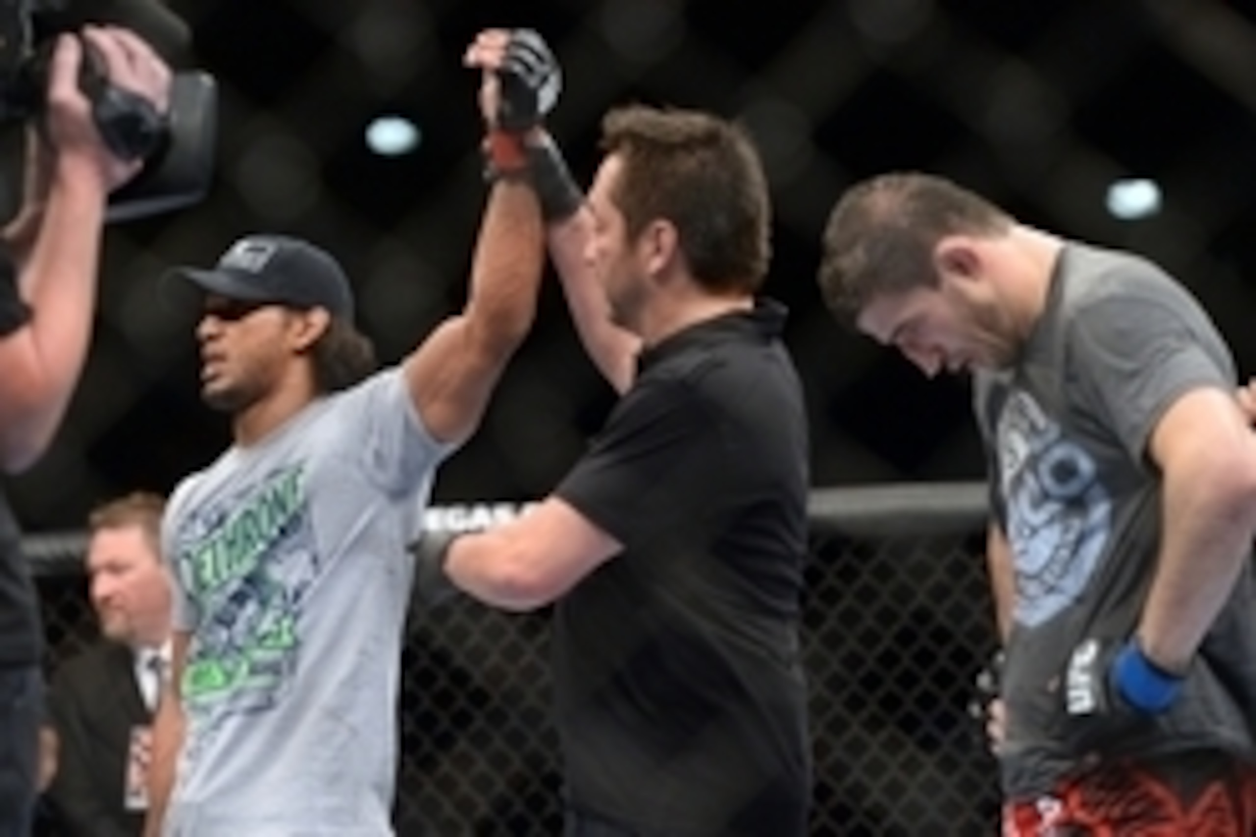 Jun 7, 2014; Albuquerque, NM, USA; Benson Henderson (red) celebrates his victory over Rustam Khabilov (blue) after their lightweight bout during UFC Fight Night 42 at Tingley Coliseum. Henderson won via fourth round submission. Mandatory Credit: Joe Campo