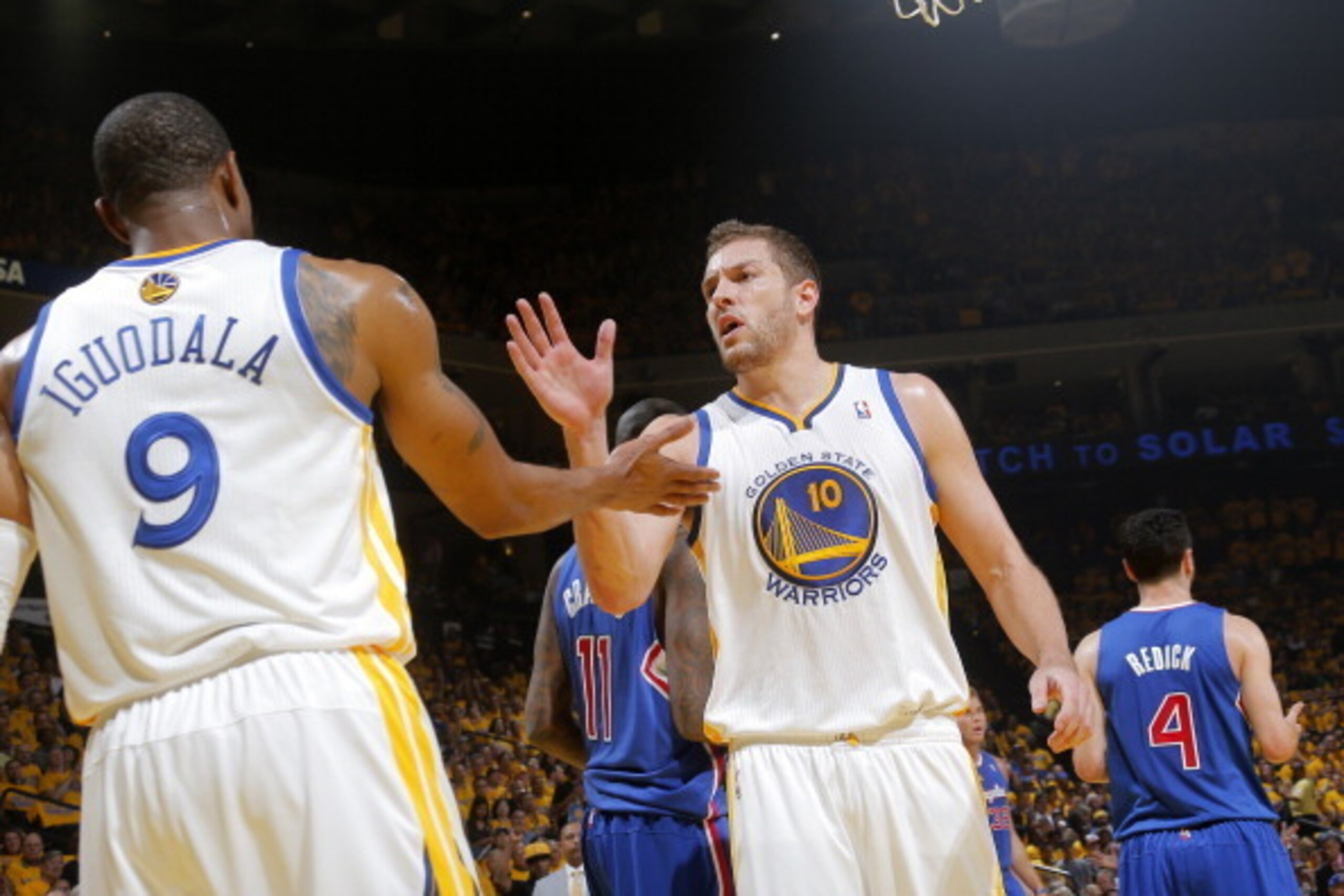 OAKLAND, CA - APRIL 24: David Lee #10 of the Golden State Warriors celebrates a play with his teammate Andre Iguodala #9 during a game against the Los Angeles Clippers in Game Three of the Western Conference Quarterfinals during the 2014 NBA Playoffs at O