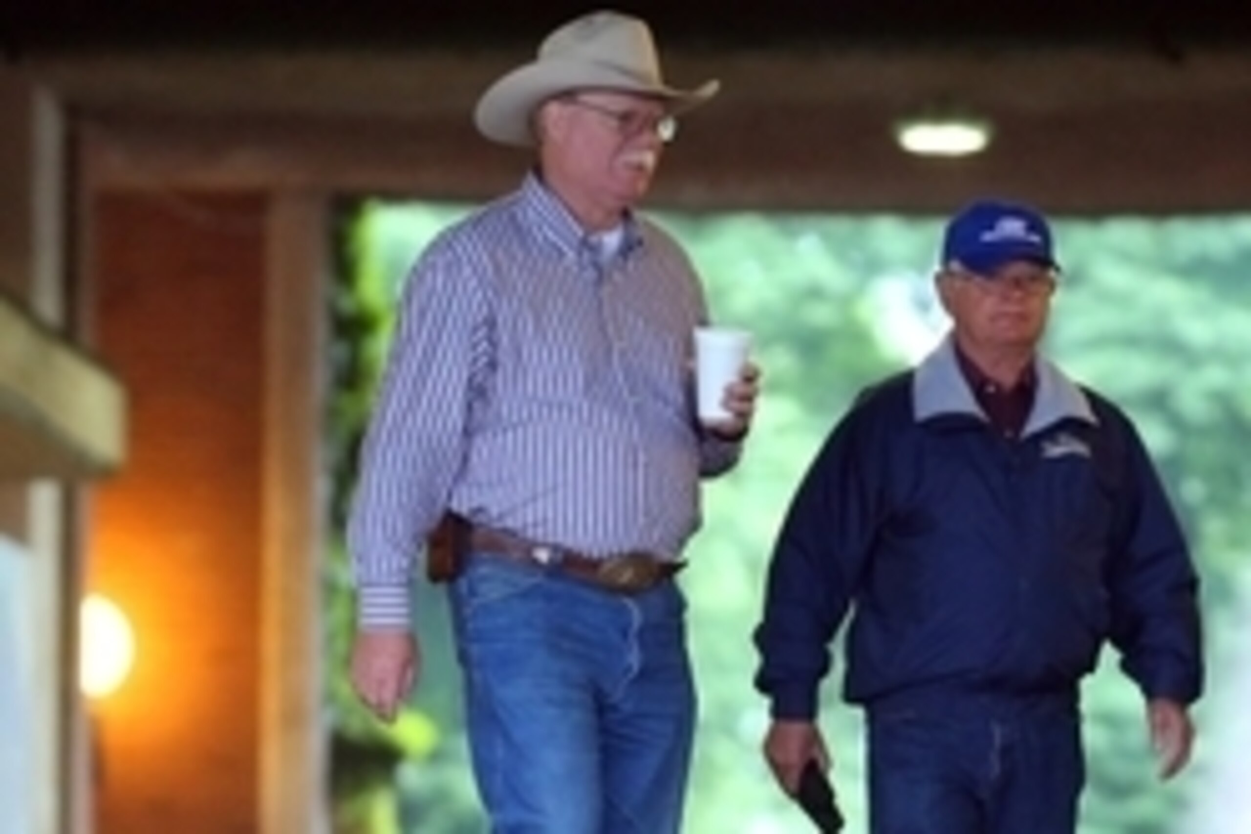 Jun 4, 2014; Elmont, NY, USA; California Chrome co owner Steve Coburn (left) and trainer Art Sherman walk from the paddock to view the morning workout in preparation for the 2014 Belmont Stakes at Belmont Park. Mandatory Credit: Anthony Gruppuso-USA TODAY