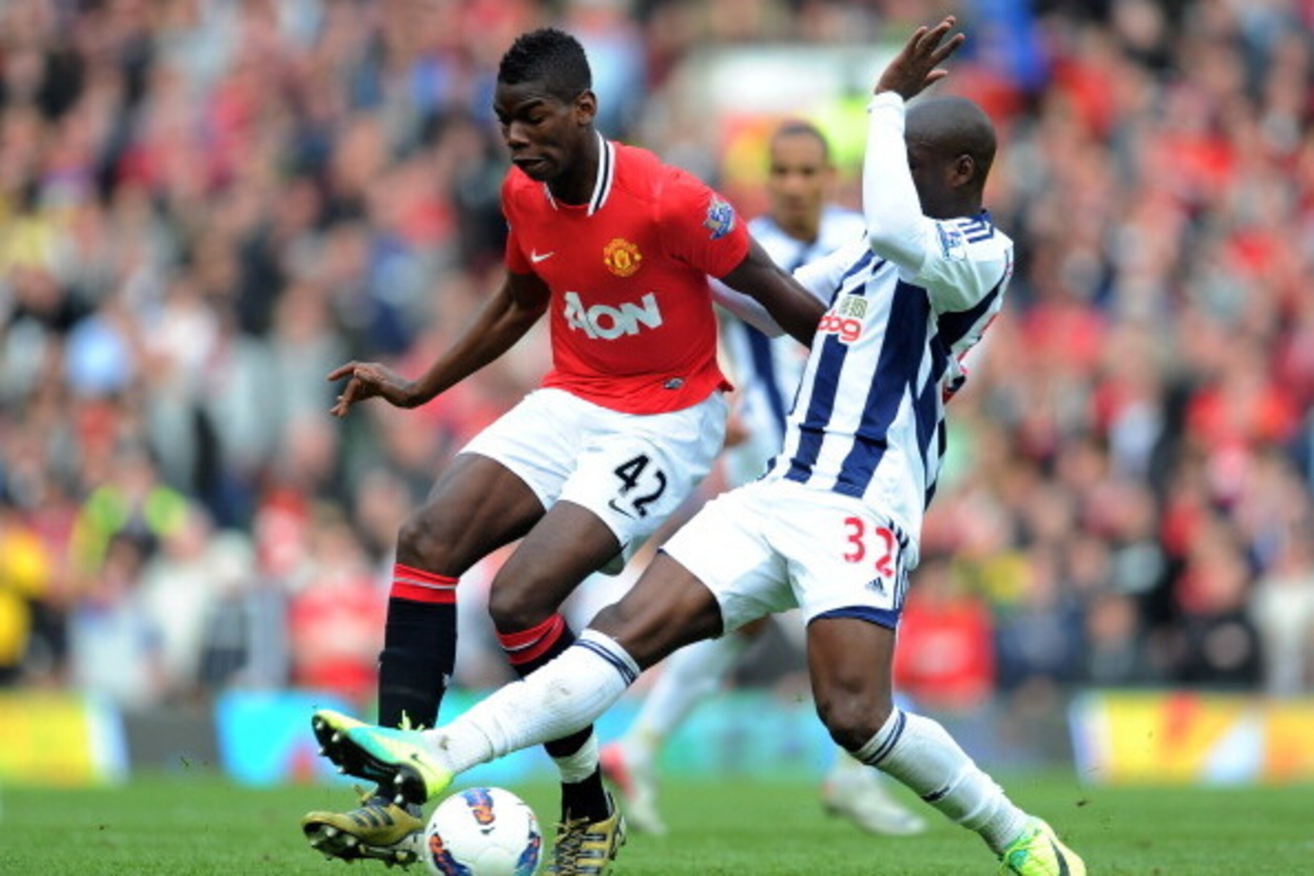 MANCHESTER, ENGLAND - MARCH 11: Paul Pogba of Manchester United is challenged by Marc-Antoine Fortune of West Bromwich Albionduring the Barclays Premier League match between Manchester United and West Bromwich Albion at Old Trafford on March 11, 2012 in MANCHESTER, ENGLAND - MARCH 11: Paul Pogba of Manchester United is challenged by Marc-Antoine Fortune of West Bromwich Albionduring the Barclays Premier League match between Manchester United and West Bromwich Albion at Old Trafford on March 11, 2012 in