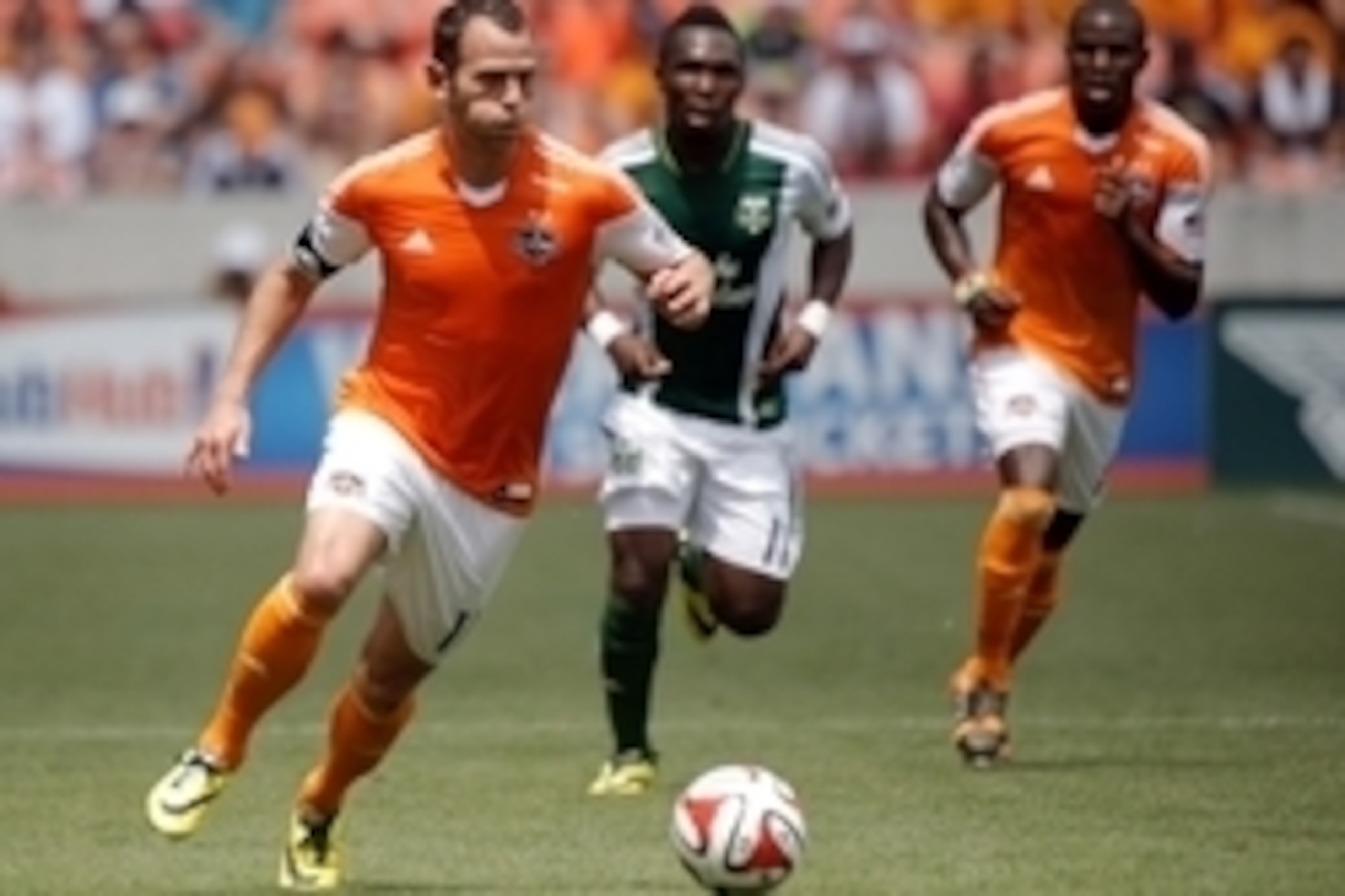 Apr 27, 2014; Houston, TX, USA; Houston Dynamo midfielder Brad Davis (11) runs with the ball during the first half against the Portland Timbers at BBVA Compass Stadium. Mandatory Credit: Andrew Richardson-USA TODAY Sports