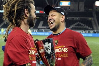 PORTLAND, OR - NOVEMBER 24: Kyle Beckerman #5 of Real Salt Lake and Nick Rimando #18 of Real Salt Lake hold the cup as they celebrate after the game at Jeld-Wen Field on November 24, 2013 in Portland, Oregon. Real Salt Lake won the match 1-0 to advance.(P