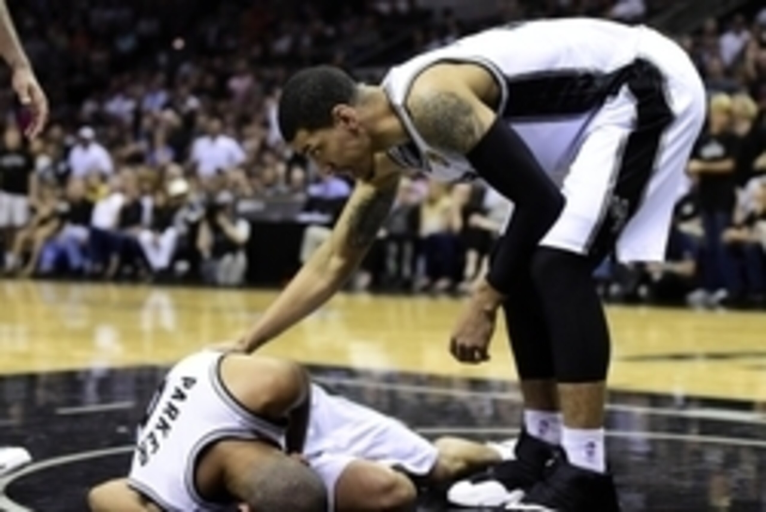 Jun 8, 2014; San Antonio, TX, USA; San Antonio Spurs guard Tony Parker (9) is checked by guard Danny Green (4) after being injured against the Miami Heat in game two of the 2014 NBA Finals at AT&T Center. Mandatory Credit: Bob Donnan-USA TODAY Sports