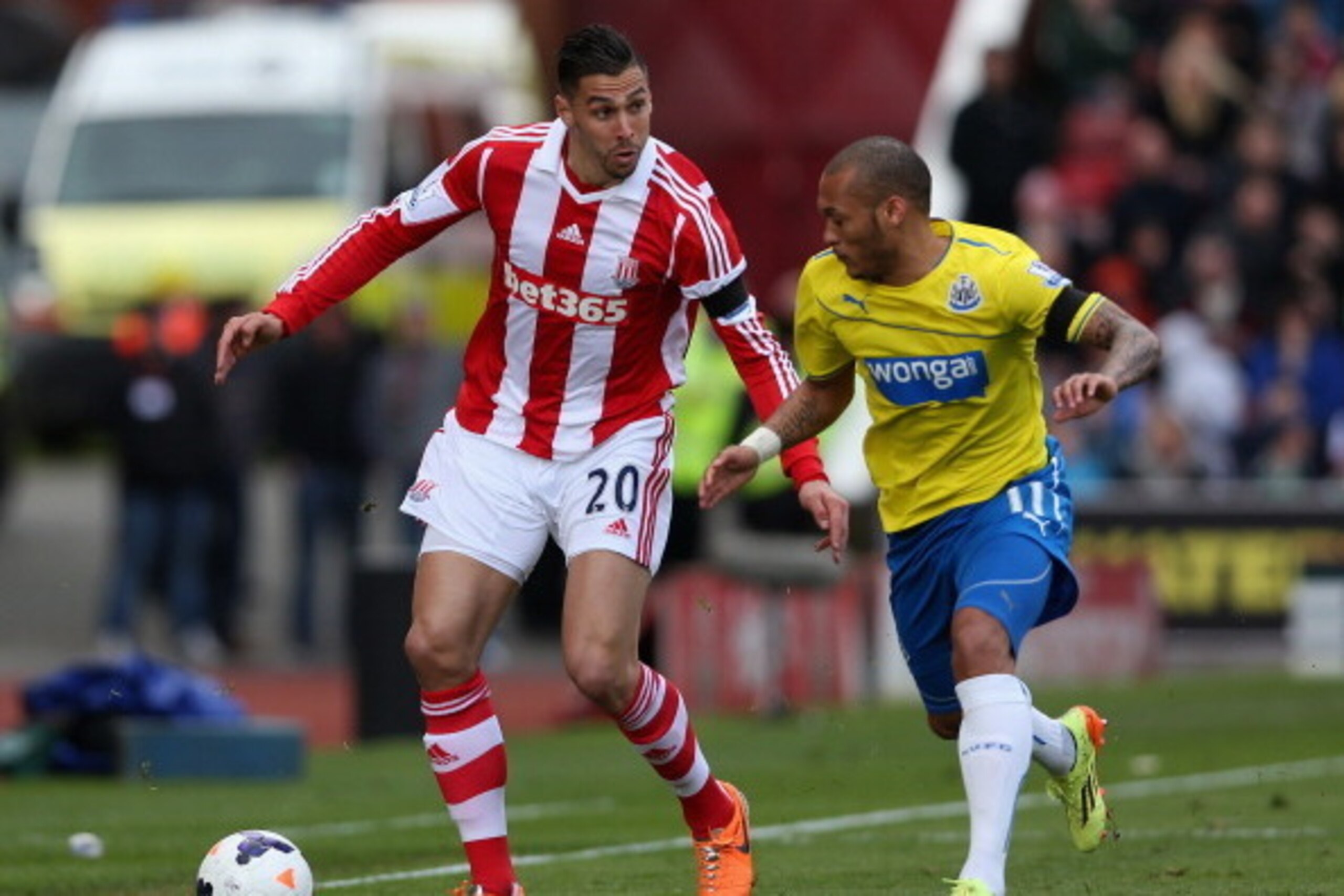 STOKE ON TRENT, ENGLAND - APRIL 12:  Dan Gosling of Newcastle United competes with Geoff Cameron of Stoke City during the Barclays Premier League match between Stoke City and Newcastle United at Britannia Stadium on April 12, 2014 in Stoke on Trent, Engla