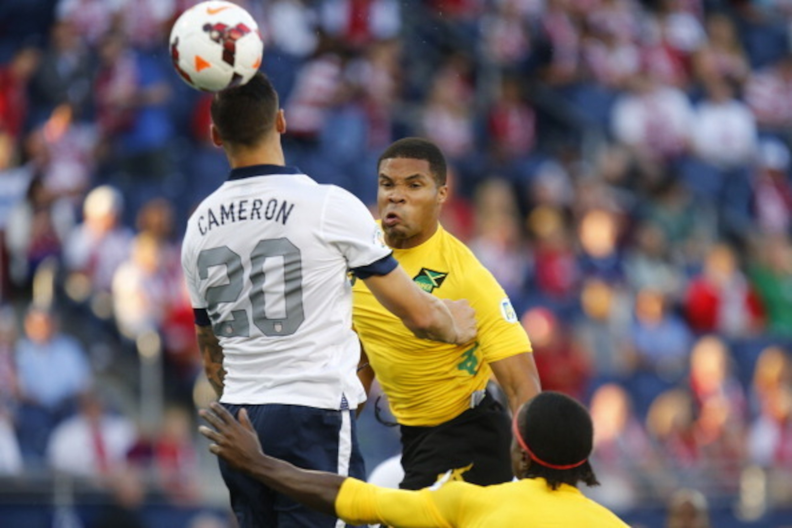 KANSAS CITY, KS - OCTOBER 11:  Ryan Johnson #9 of Jamaica heads a shot over Geoff Cameron #20 of the U.S. Men's National Soccer Team in the first half at Sporting Park on October 11, 2013 in Kansas City, Kansas.  (Photo by Kyle Rivas/Getty Images)