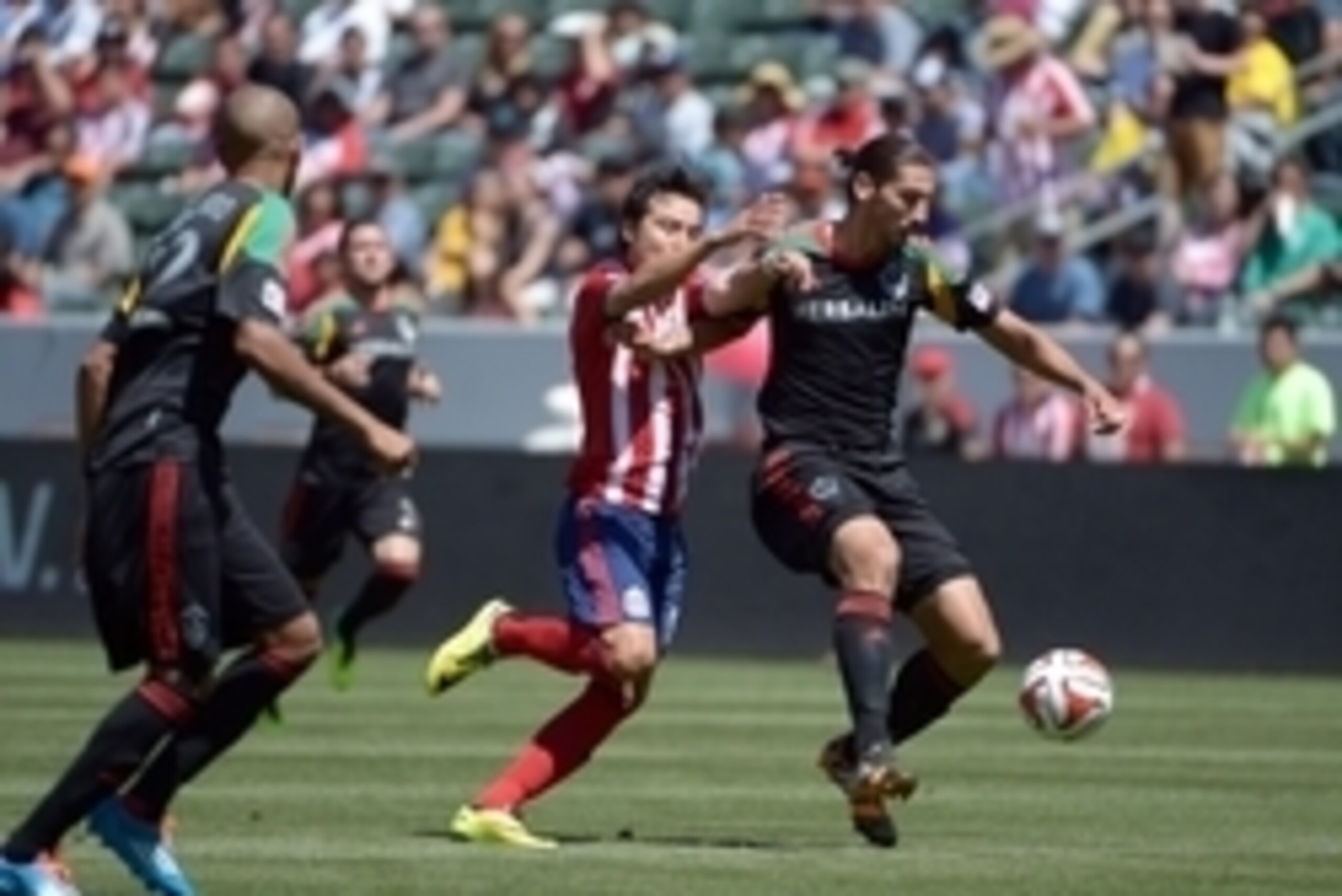 Apr 6, 2014; Carson, CA, USA; Los Angeles Galaxy defender Omar Gonzalez (4) battles for the ball with Chivas USA forward Erick Torres (9 at StubHub Center. The Galaxy defeated Chivas USA 3-0.  Mandatory Credit: Kirby Lee-USA TODAY Sports