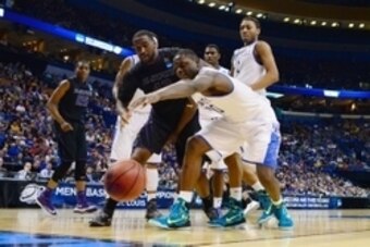 Mar 21, 2014; St. Louis, MO, USA; Kentucky Wildcats forward Julius Randle (30) reaches for a loose ball ahead of Kansas State Wildcats forward Thomas Gipson (42) in the second half during the 2nd round of the 2014 NCAA Men's Basketball Championship at Sco