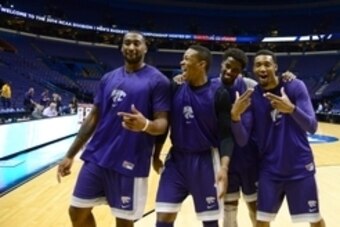 Mar 20, 2014; St. Louis, MO, USA; Kansas State Wildcats forward Thomas Gipson (left), Marcus Foster (left center), Nino Williams (right center) and Shane Southwell (right) react to the camera during their practice session prior to the 2nd round of the 201
