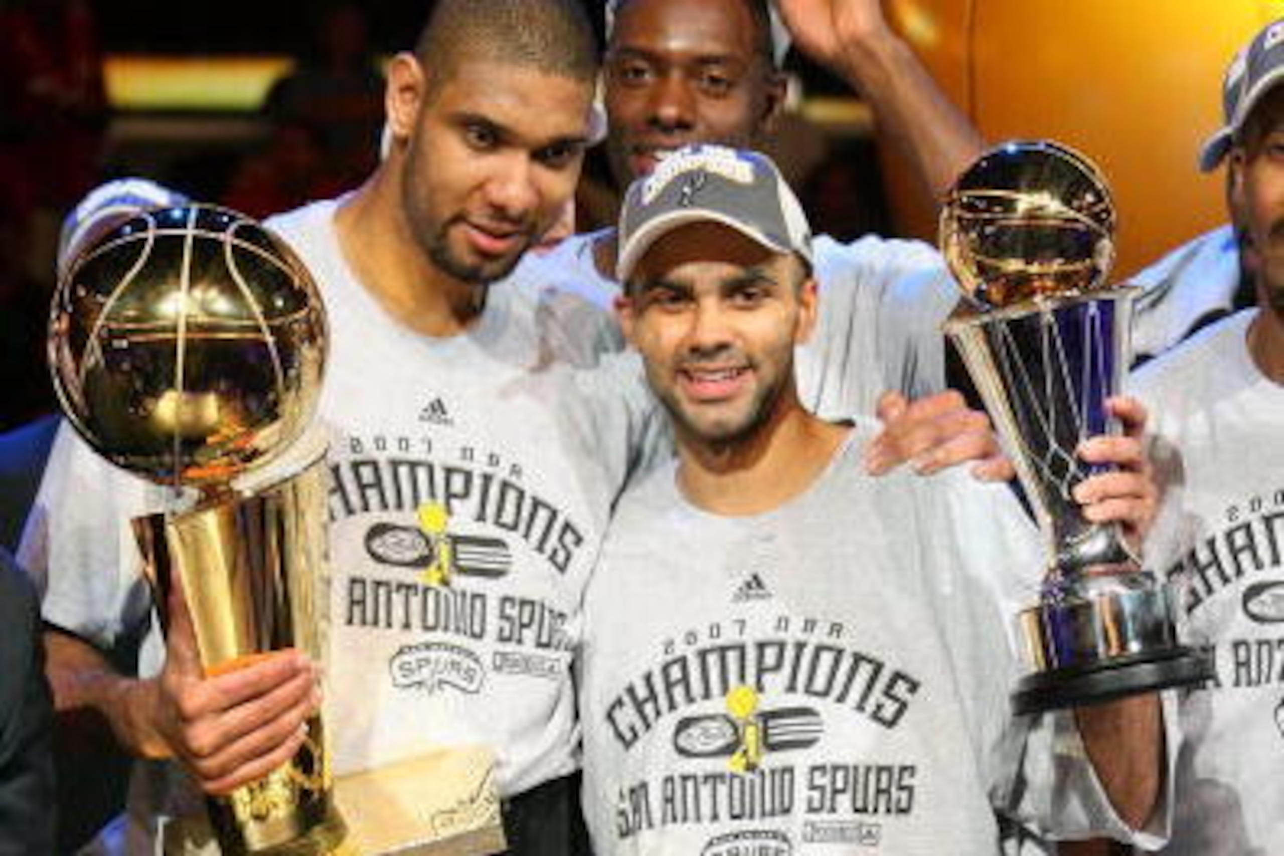 CLEVELAND - JUNE 14:  Tim Duncan #21 and Finals MVP Tony Parker #9 of the San Antonio Spurs celebrate with the Larry O'Brien Trophy and MVP Trophy after they won the NBA Championship with their 83-82 win against the Cleveland Cavaliers in Game Four of the