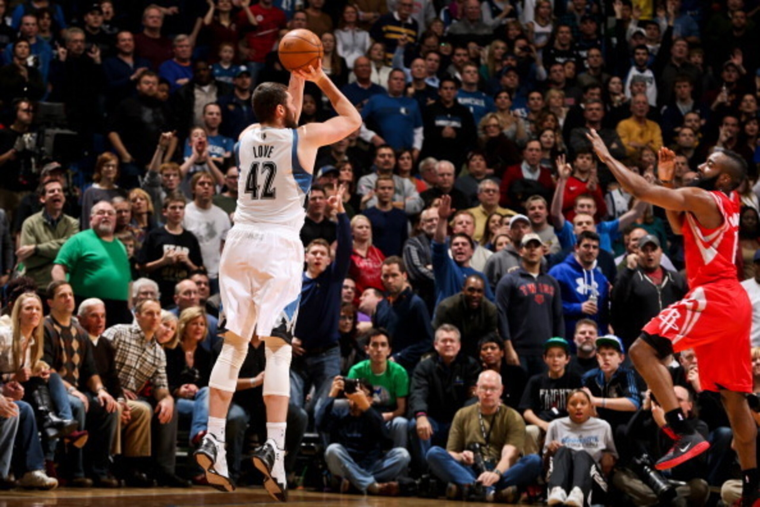 MINNEAPOLIS, MN - DECEMBER 26: Kevin Love #42 of the Minnesota Timberwolves shoots a three-pointer against James Harden #13 of the Houston Rockets on December 26, 2012 at Target Center in Minneapolis, Minnesota. NOTE TO USER: User expressly acknowledges a