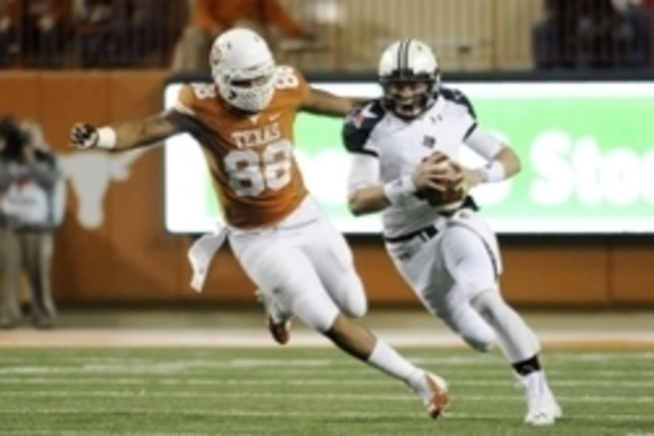 Nov 28, 2013; Austin, TX, USA; Texas Tech Red Raiders quarterback Baker Mayfield (6) away from Texas Longhorns defensive end Cedric Reed (88) during the first quarter at Darrell K Royal-Texas Memorial Stadium. Mandatory Credit: Brendan Maloney-USA TODAY S