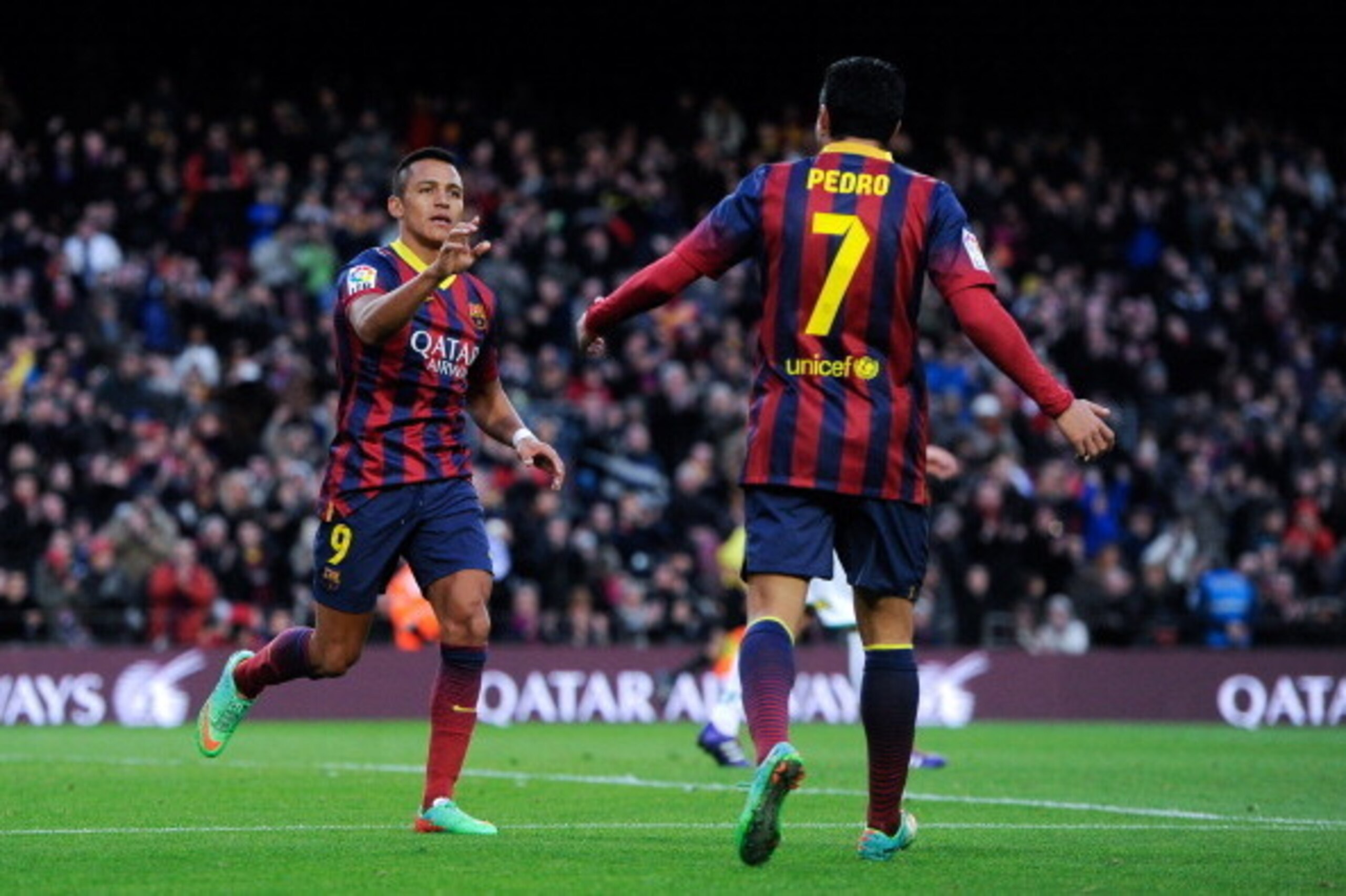 BARCELONA, SPAIN - JANUARY 05:  Alexis Sanchez of FC Barcelona celebrates with his teammate Pedro Rodriguez of FC Barcelona after scoring his team's third goal during the La Liga match between FC Barcelona and Elche FC at Camp Nou on January 5, 2014 in Ba