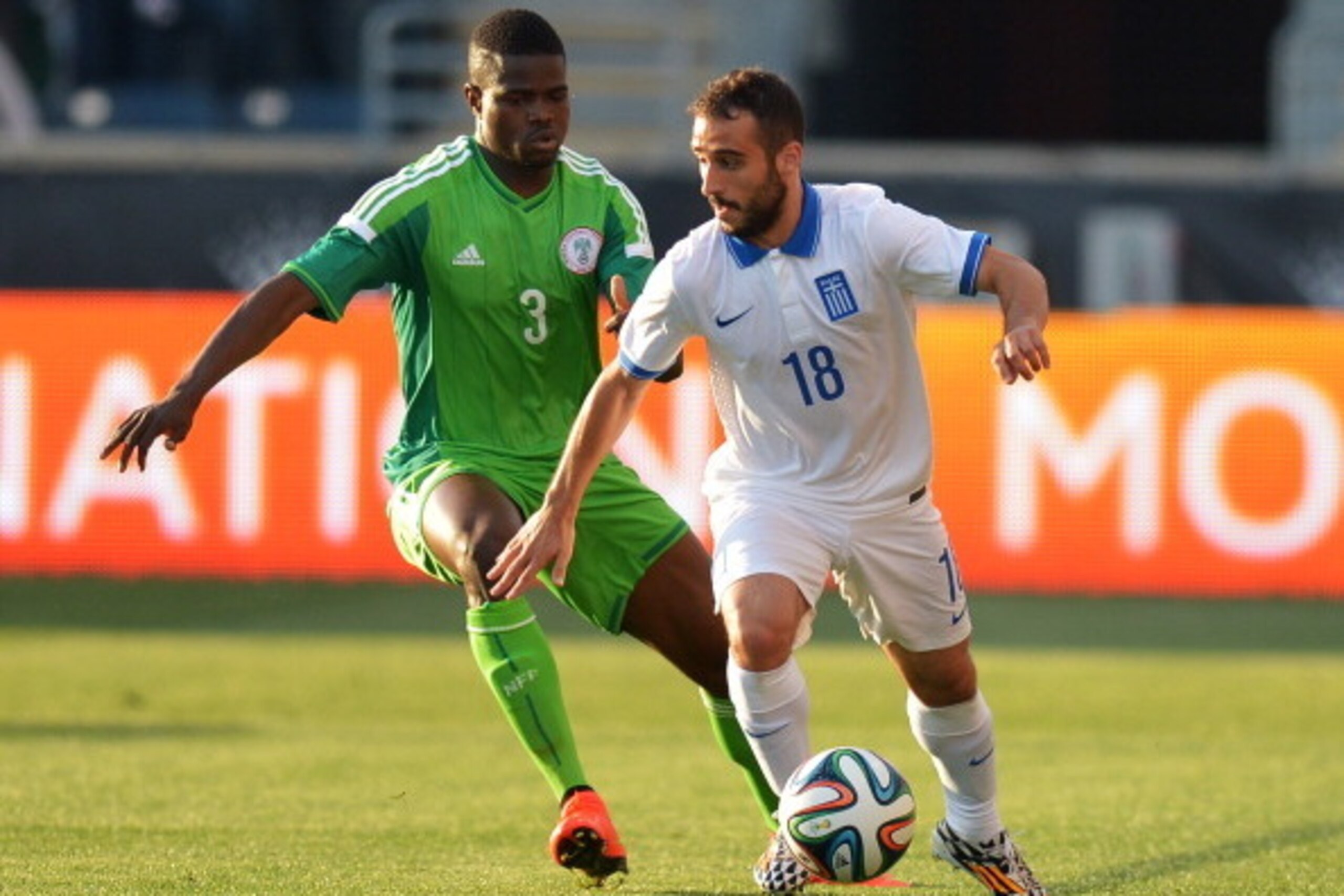 CHESTER, PA - JUNE 3: Ioannis Fetfatzidis #18 of Greece tries to work the ball around Elderson Echiéjilé #3 of Nigeria during an international friendly match at PPL Park on June 3, 2014 in Chester, Pennsylvania.  (Photo by Drew Hallowell/Getty Images)