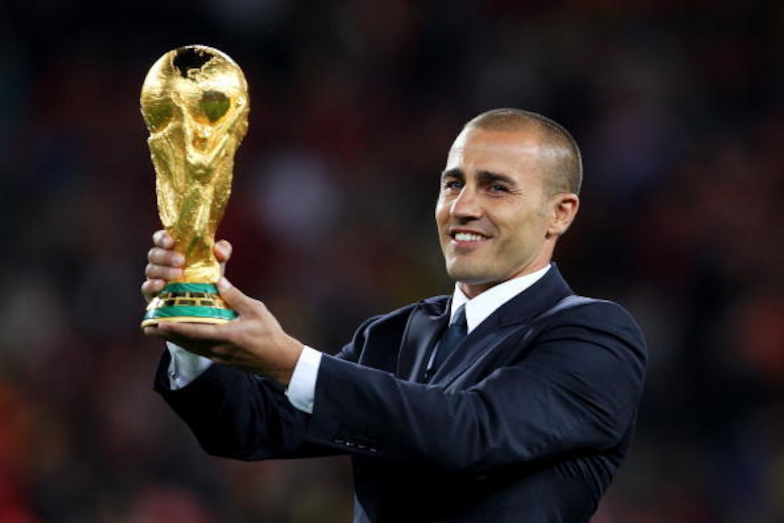 JOHANNESBURG, SOUTH AFRICA - JULY 11:  Captain of the 2006 FIFA World Cup winning team Fabio Cannavaro presents the World Cup on the pitch ahead of the 2010 FIFA World Cup South Africa Final match between Netherlands and Spain at Soccer City Stadium on Ju