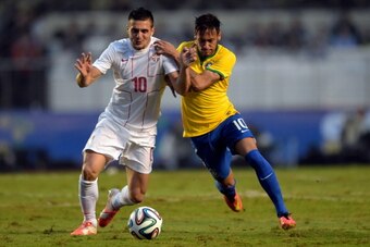 SAO PAULO, BRAZIL - JUNE 06:  Neymar (R) of Brazil and Tadic of Serbia compete for the ball during the International Friendly Match between Brazil and Serbia at Morumbi Stadium on June 06, 2014 in Sao Paulo, Brazil.  (Photo by Buda Mendes/Getty Images)