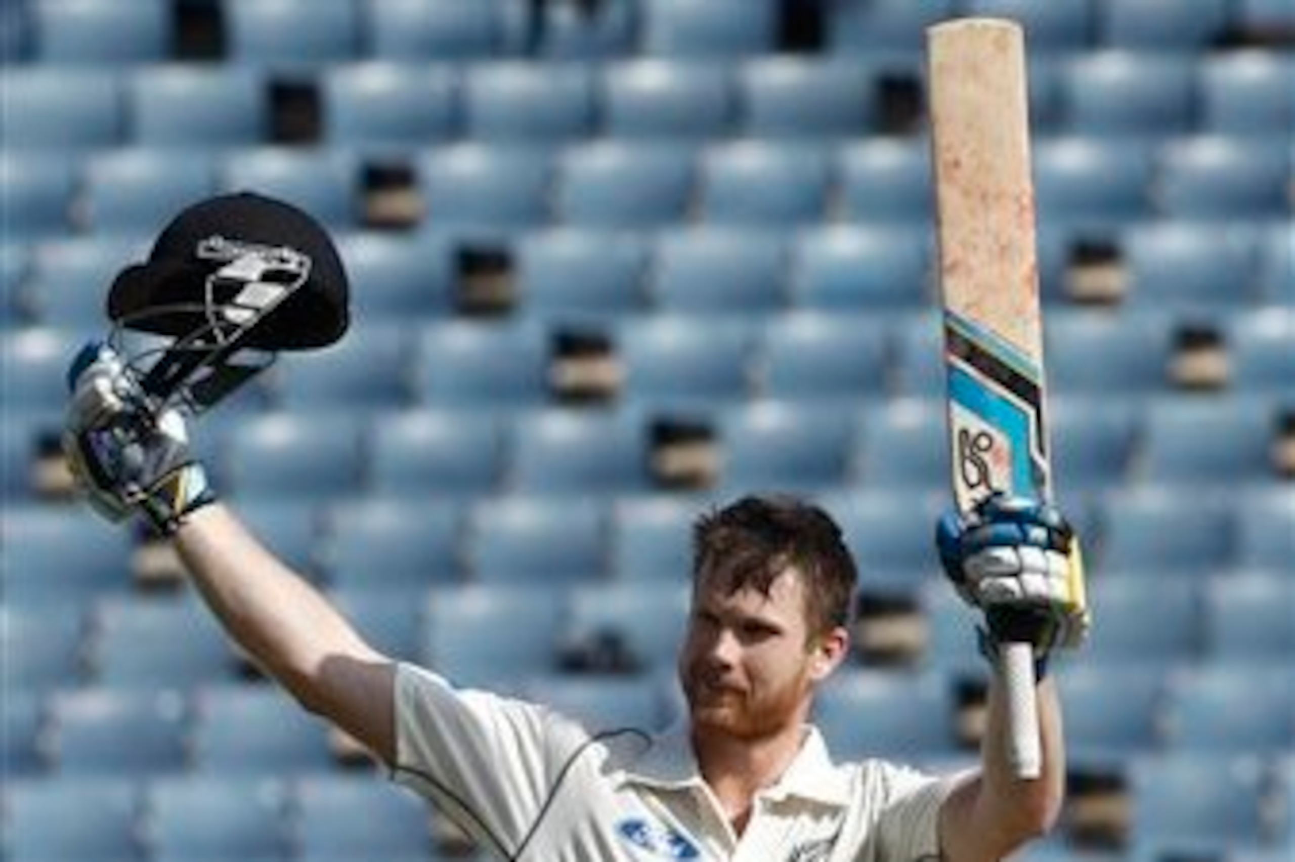 Jimmy Neesham celebrates his century.