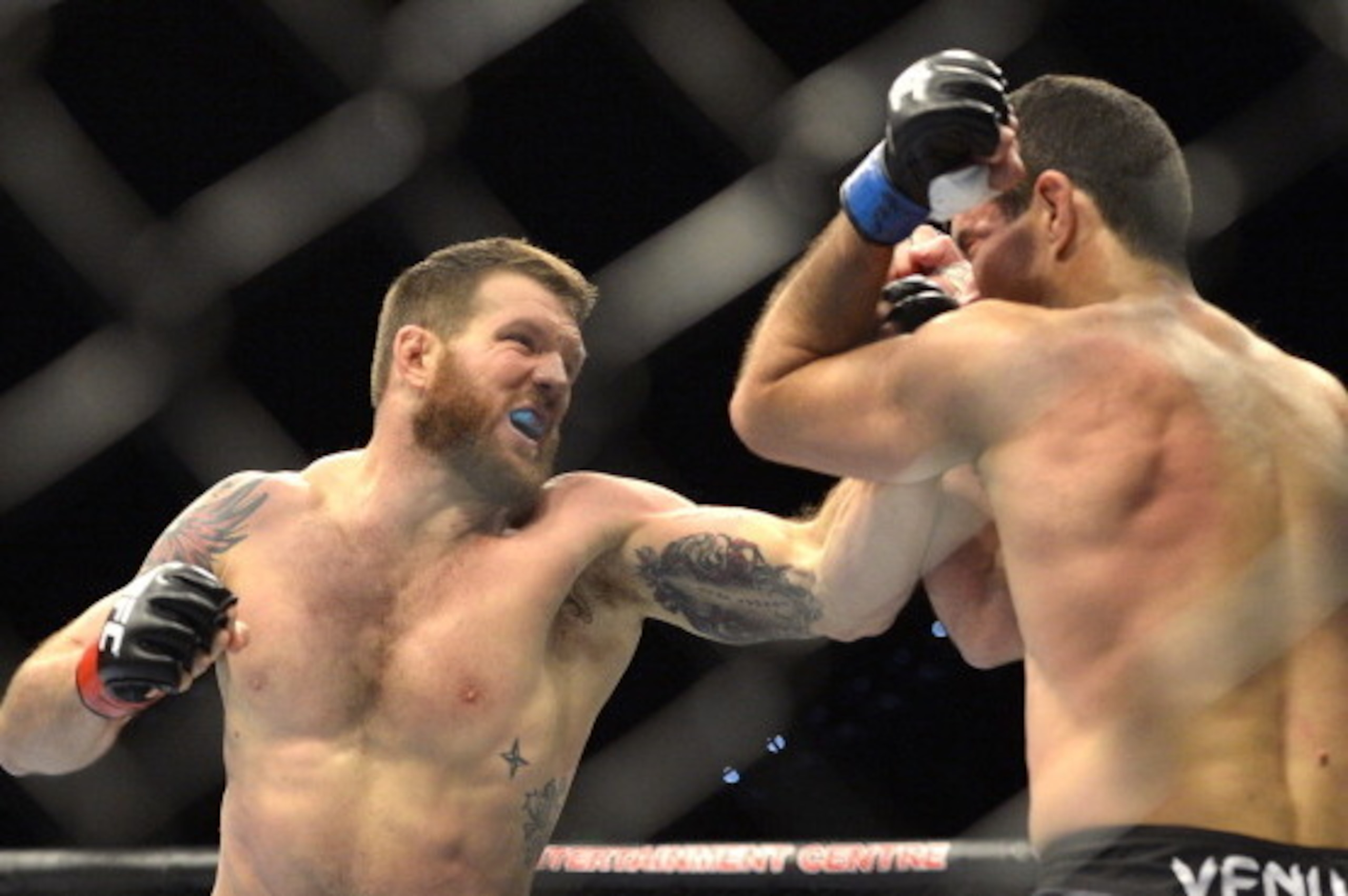 BRISBANE, AUSTRALIA - DECEMBER 07:  Ryan Bader of the USA punches Anthony Perosh of Australia during their UFC Fight Night Brisbane bout at the Brisbane Entertainment Centre on December 7, 2013 in Brisbane, Australia.   (Photo by Bradley Kanaris/Getty Ima