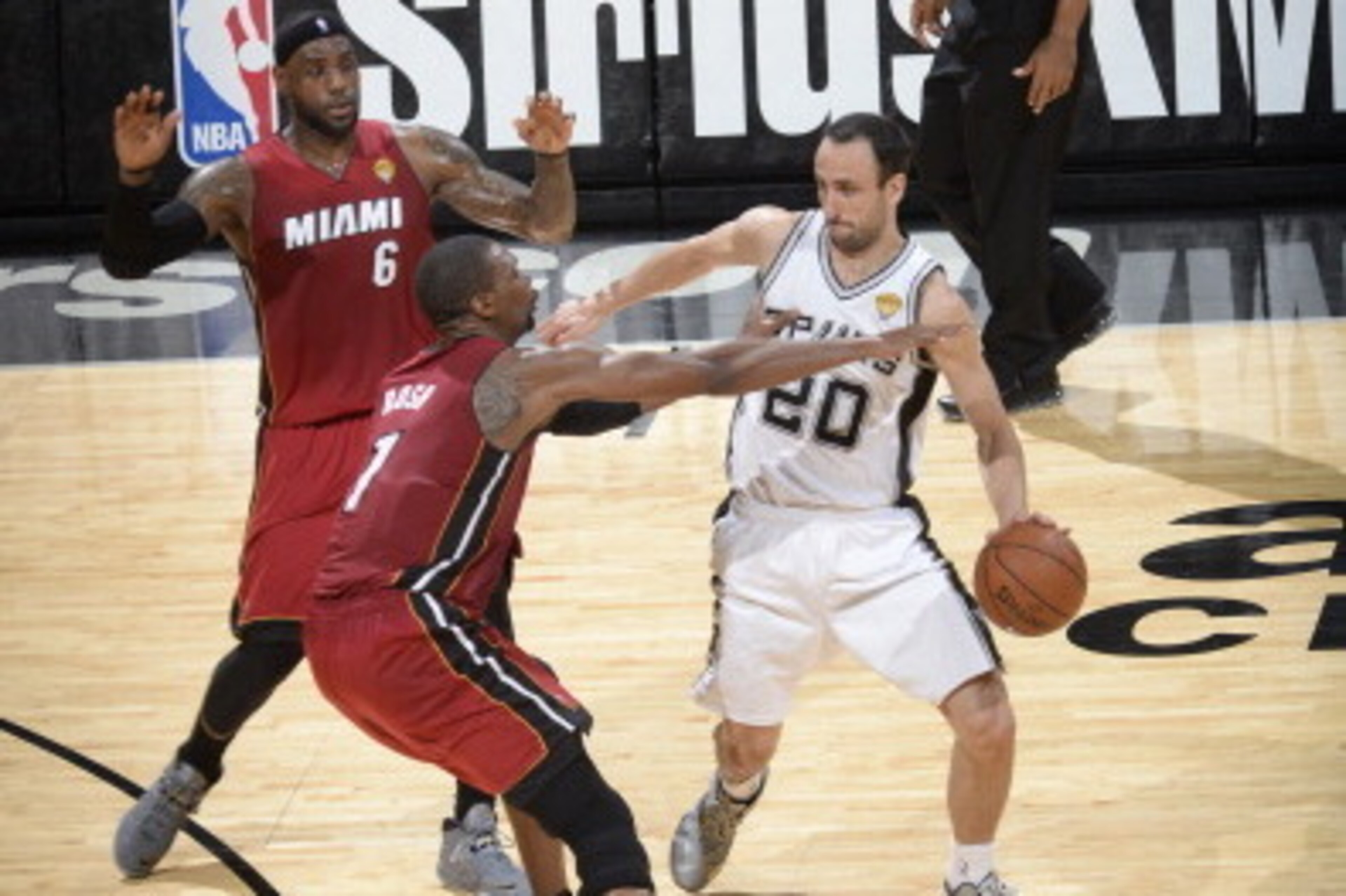 SAN ANTONIO, TX - June 5: Manu Ginobili #20 of the San Antonio Spurs drives against Chris Bosh #1 and LeBron James #6 of the Miami Heat in Game One of the 2014 NBA Finals on June 5, 2014 at the AT&T Center in San Antonio, Texas. NOTE TO USER: User express
