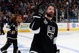 LOS ANGELES, CA - JUNE 07:  Justin Williams #14 of the Los Angeles Kings waves to the crowd after the Kings defeated the New York Rangers 5-4 with an overtime goal scored by Dustin Brown #23 (not pictured) in Game Two of the 2014 Stanley Cup Final at Stap