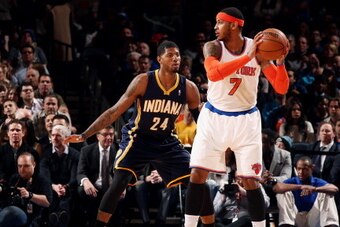 NEW YORK, NY - MARCH 19: Carmelo Anthony #7 of the New York Knicks handles the ball against Paul George #24 of the Indiana Pacers at Madison Square Garden in New York City on March 19, 2014.  NOTE TO USER: User expressly acknowledges and agrees that, by d
