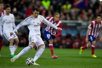 MADRID, SPAIN - FEBRUARY 11:  Cristiano Ronaldo of Real Madrid CF scores their opening goal from a penalty shot during the Copa del Rey semi-final second leg match between Club Atletico de Madrid and Real Madrid CF at Vicente Calderon Stadium on February 