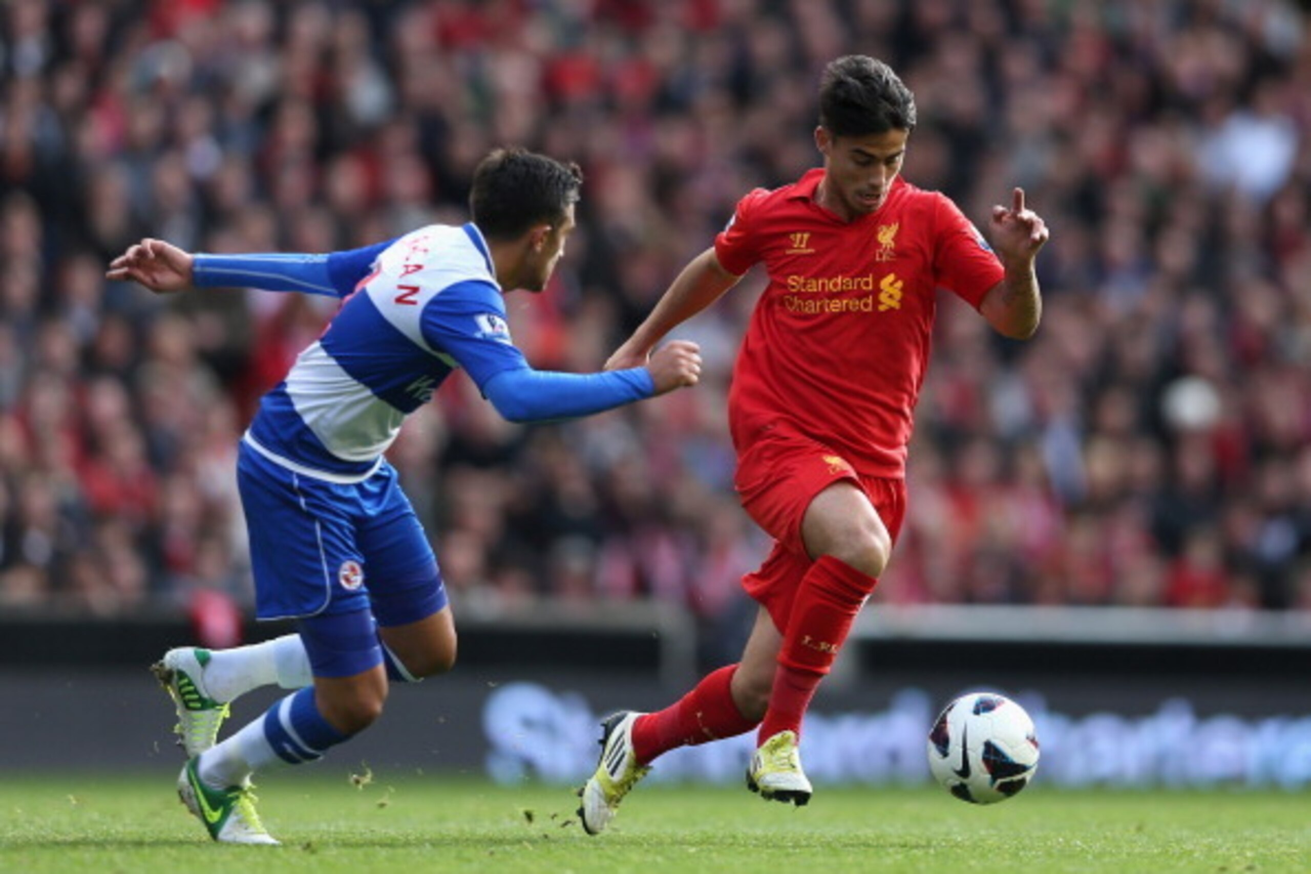 LIVERPOOL, ENGLAND - OCTOBER 20:  Jem Karacan of Reading competes with Suso of Liverpool during the Barclays Premier League match between Liverpool and Reading at Anfield on October 20, 2012 in Liverpool, England. (Photo by Clive Brunskill/Getty Images)