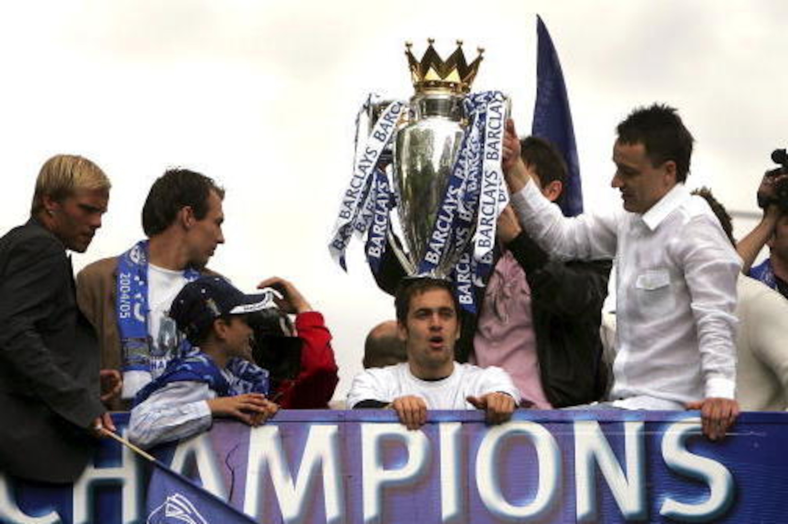 LONDON - MAY 22:  Chelsea captian John Terry holds the FA Barclays Premiership trophy on Joe Cole's head during Chelsea Football Club's trophy parade, May 22, 2005 in London.  (Photo by Bruno Vincent/Getty Images)