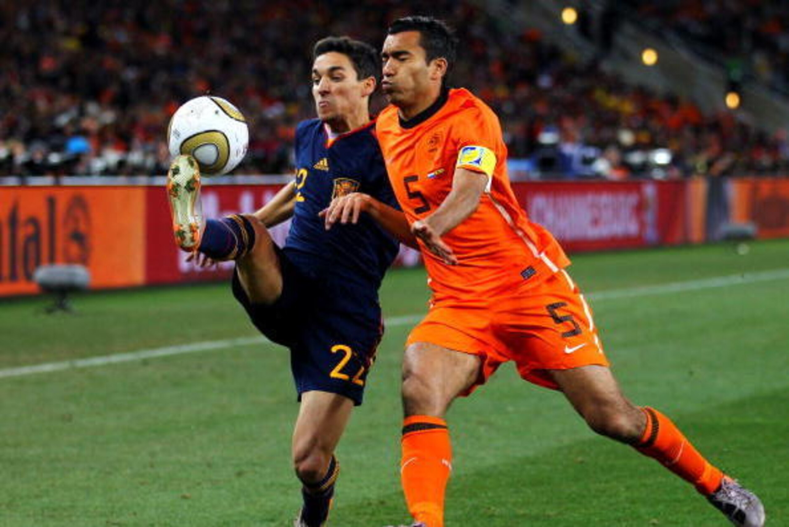 JOHANNESBURG, SOUTH AFRICA - JULY 11:  Jesus Navas of Spain and Giovanni Van Bronckhorst of the Netherlands battle for the ball during the 2010 FIFA World Cup South Africa Final match between Netherlands and Spain at Soccer City Stadium on July 11, 2010 i