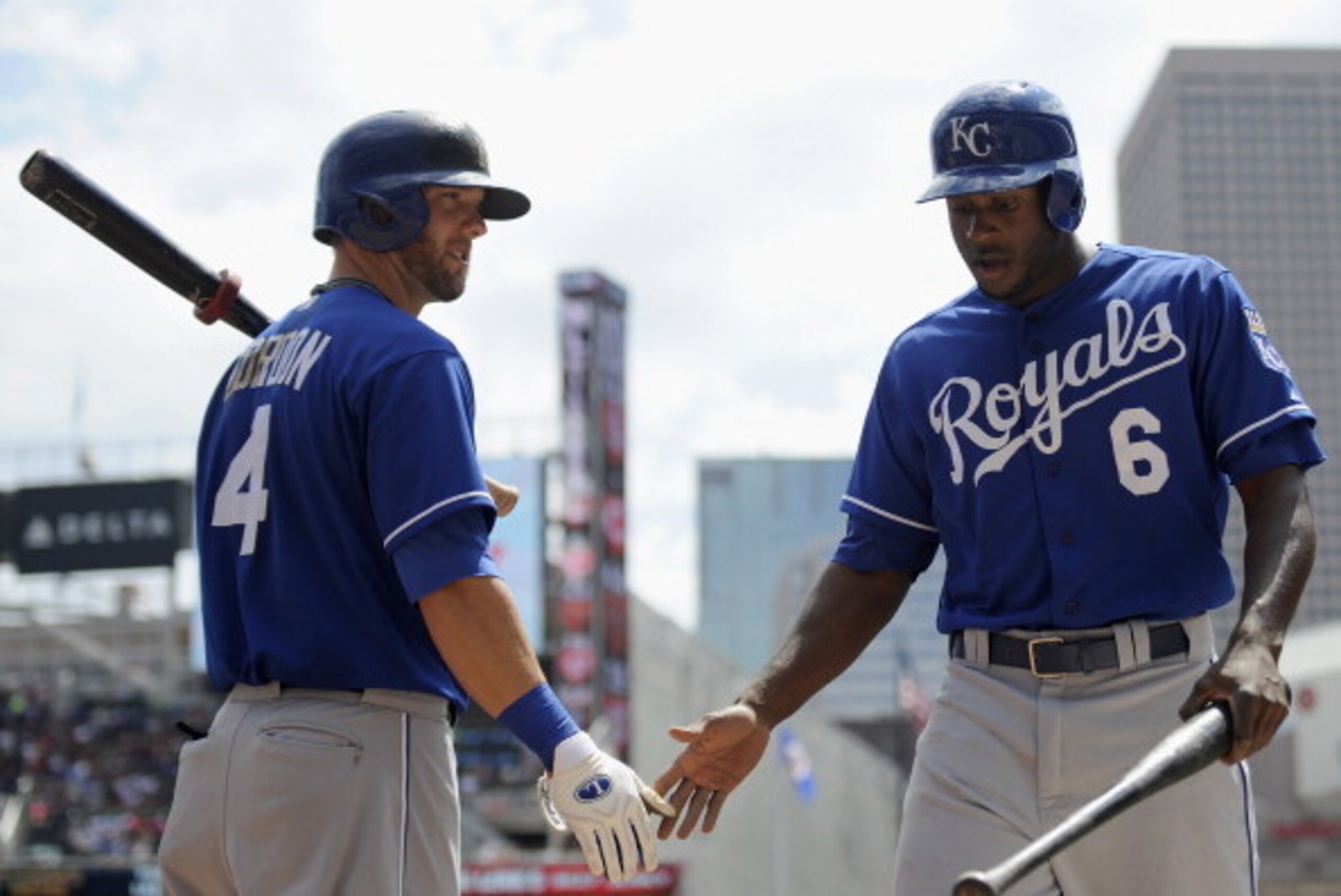 MINNEAPOLIS, MN - AUGUST 1: Alex Gordon #4 of the Kansas City Royals congratulates teammate Lorenzo Cain #6 of the Kansas City Royals on scoring a run against the Minnesota Twins during the second inning of the game on August 1, 2013 at Target Field in Mi