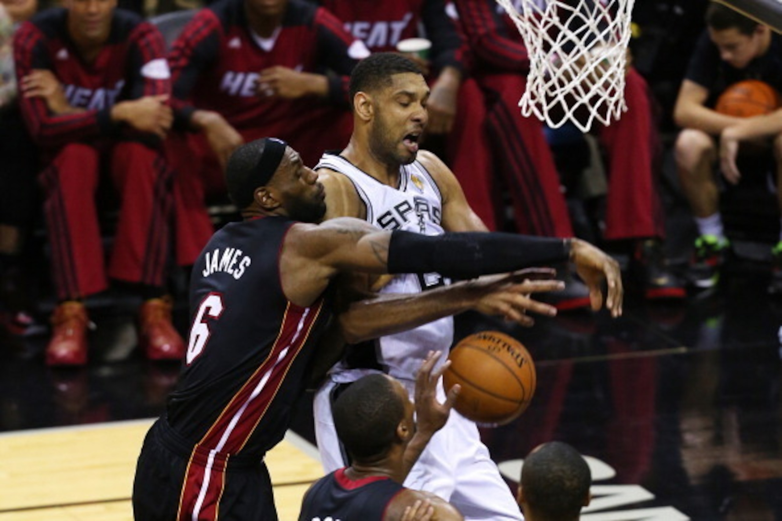 SAN ANTONIO, TX - JUNE 8:  LeBron James #6 of the Miami Heat fouls Tim Duncan #21 of the San Antonio Spurs in Game Two of the 2014 NBA Finals at the AT&T Center on June 8, 2014 in San Antonio, Texas. NOTE TO USER: User expressly acknowledges and agrees th