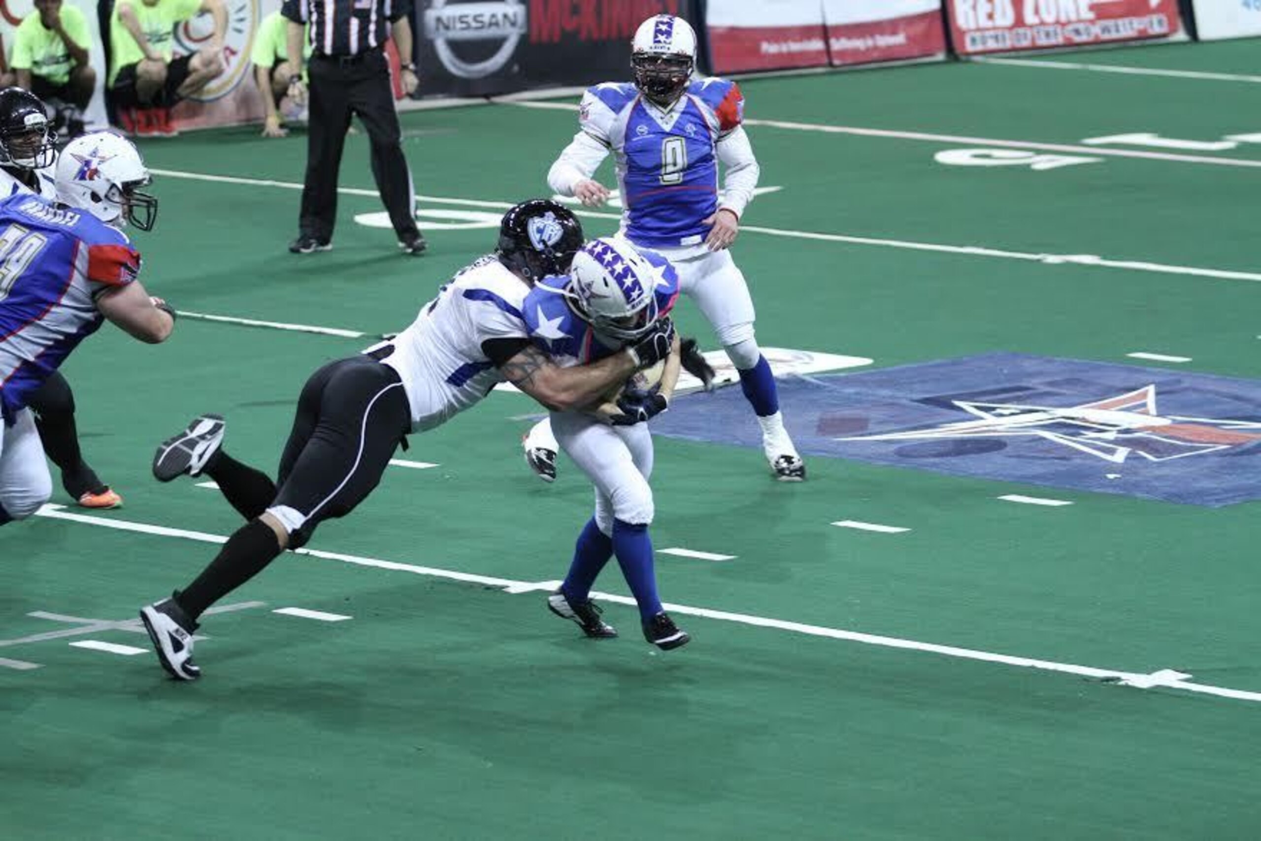 Jen Welter, carrying the ball, is the first woman to play a non-kicker position in a professional men's football league.