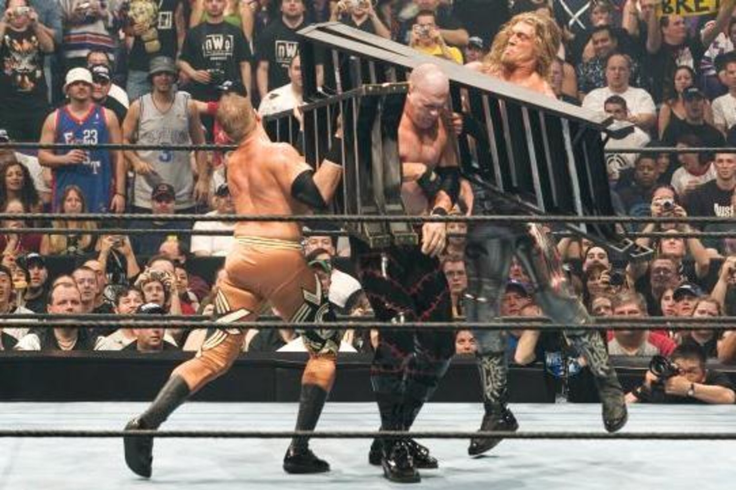 Christian and Edge smash Kane with ladders.
