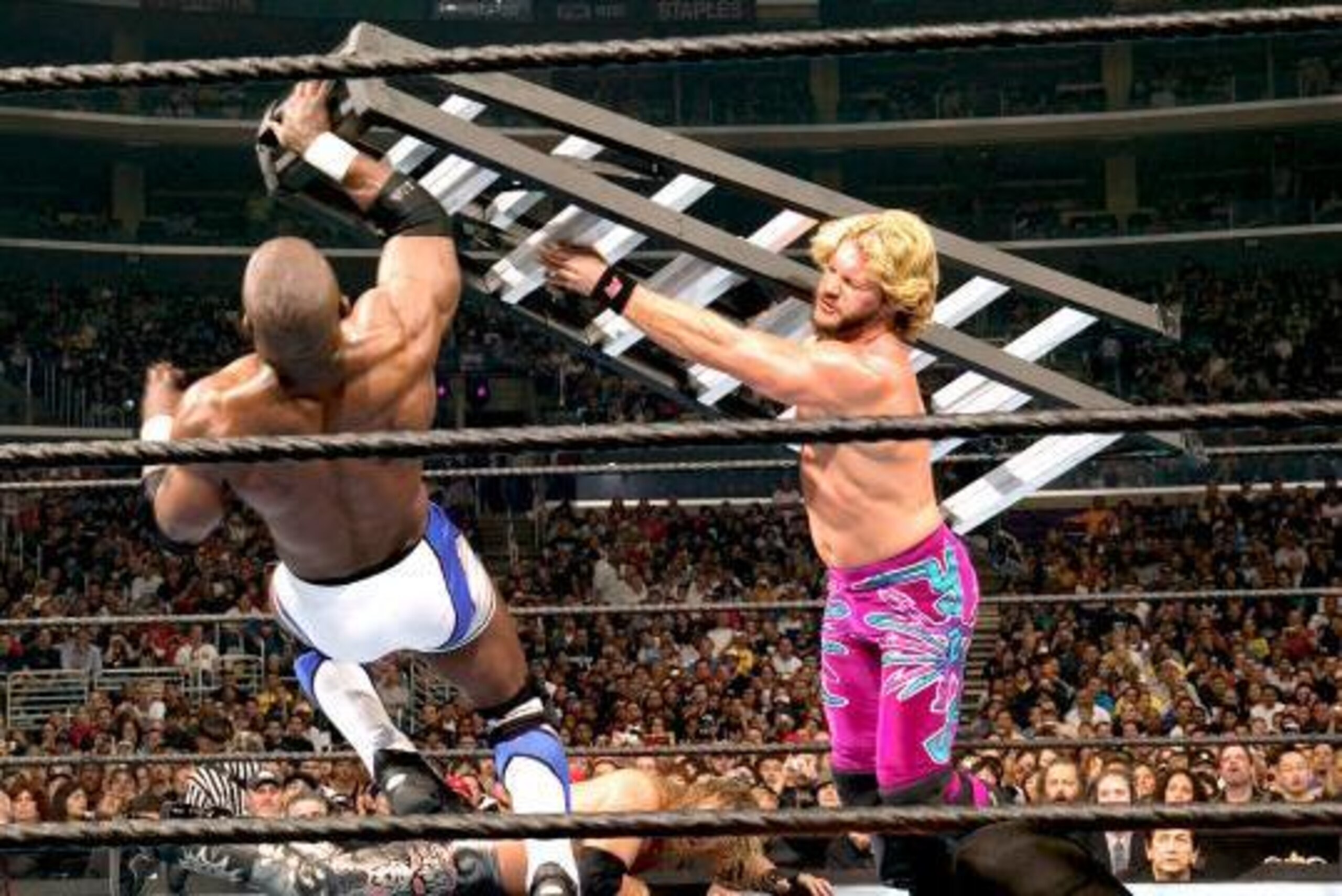 Chris Jericho nails Shelton Benjamin with a ladder.