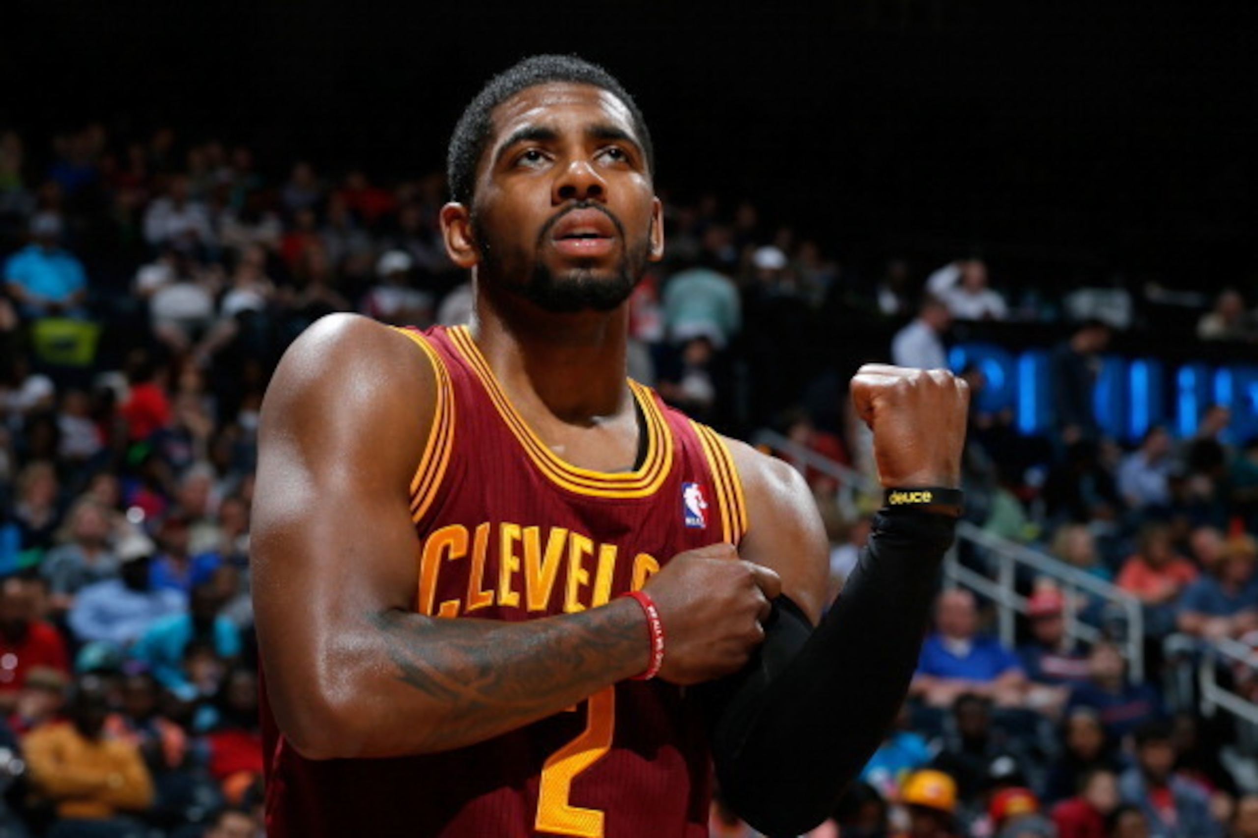 ATLANTA, GA - APRIL 04:  Kyrie Irving #2 of the Cleveland Cavaliers grabs his arm after falling out of bounds with the ball against the Atlanta Hawks at Philips Arena on April 4, 2014 in Atlanta, Georgia.  NOTE TO USER: User expressly acknowledges and agr