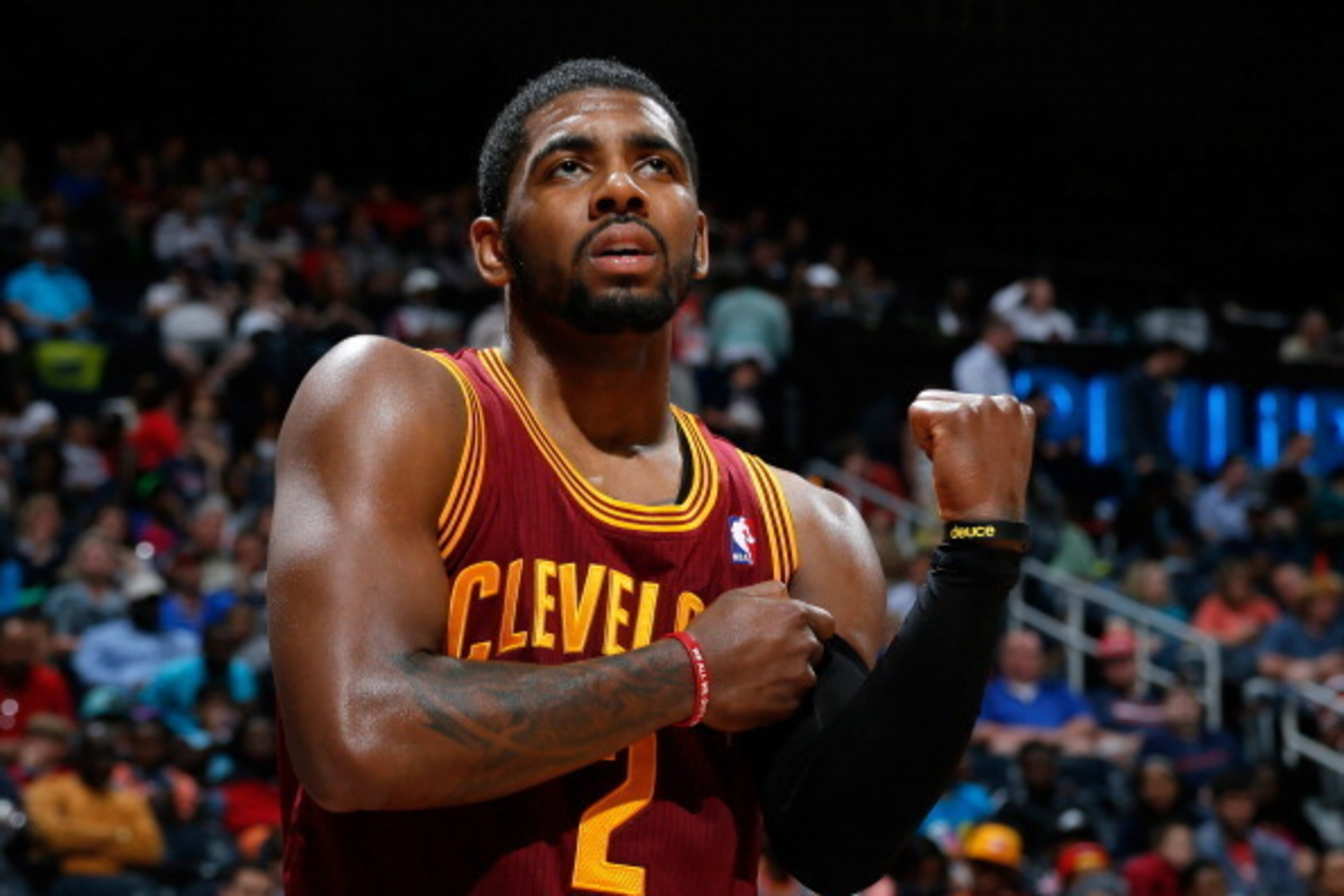 ATLANTA, GA - APRIL 04:  Kyrie Irving #2 of the Cleveland Cavaliers grabs his arm after falling out of bounds with the ball against the Atlanta Hawks at Philips Arena on April 4, 2014 in Atlanta, Georgia.  NOTE TO USER: User expressly acknowledges and agr