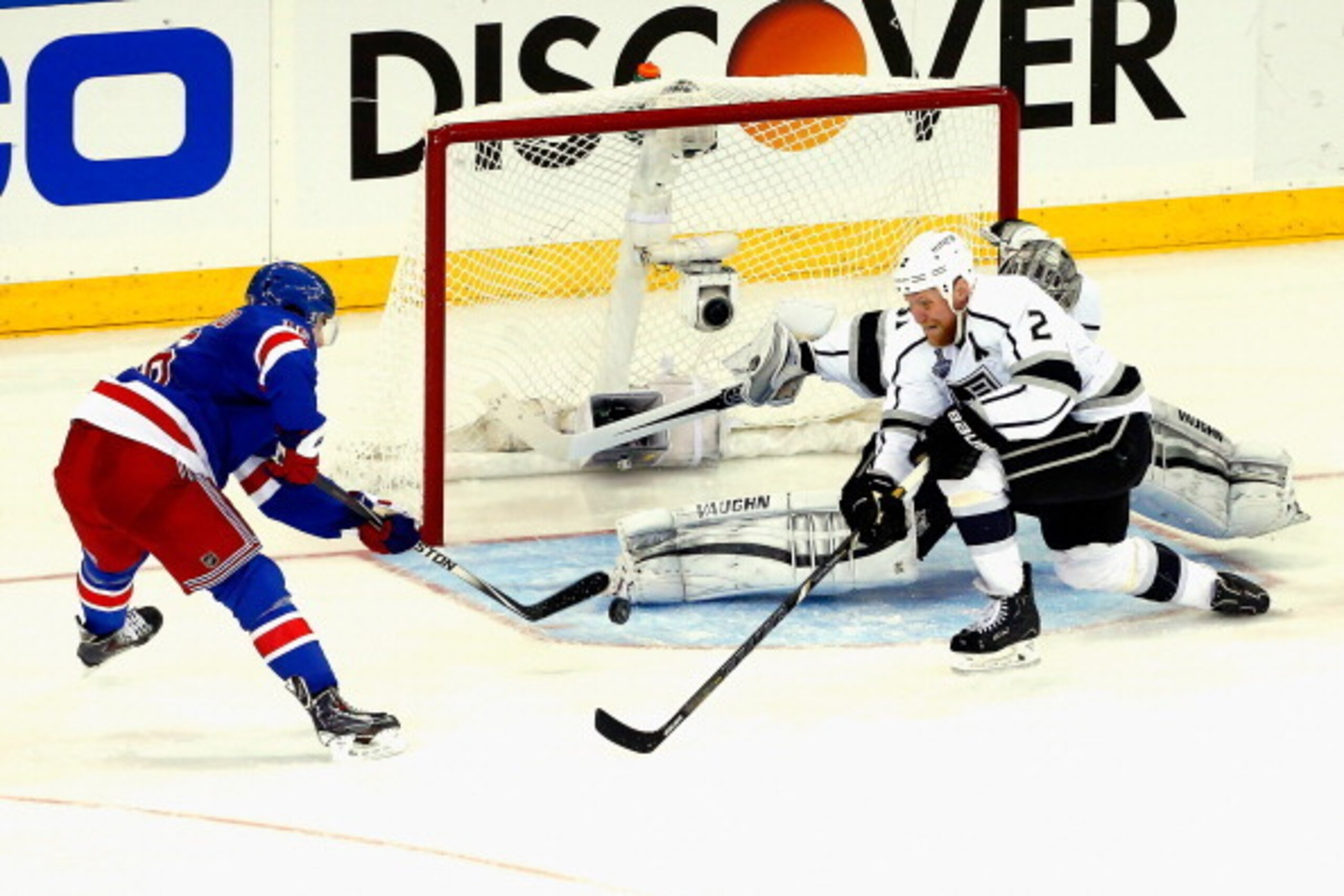 NEW YORK, NY - JUNE 09:  Matt Greene #2 of the Los Angeles Kings pokes the puck away from Derick Brassard #16 of the New York Rangers in defense of Jonathan Quick #32 of the Los Angeles Kings during the second period of Game Three of the 2014 NHL Stanley 