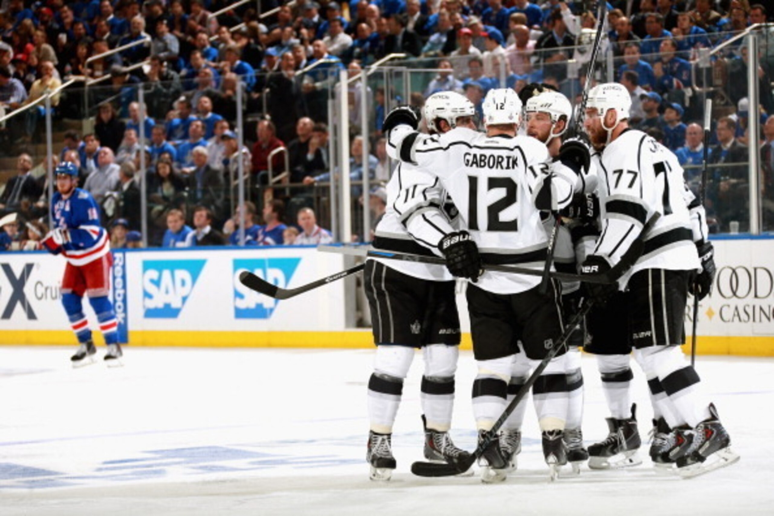 NEW YORK, NY - JUNE 09:  Jake Muzzin #6 of the Los Angeles Kings celebrates with his linemates Marian Gaborik #12 and Jeff Carter #77 after scoring against the New York Rangers during the second period of Game Three of the 2014 Stanley Cup Final at Madiso