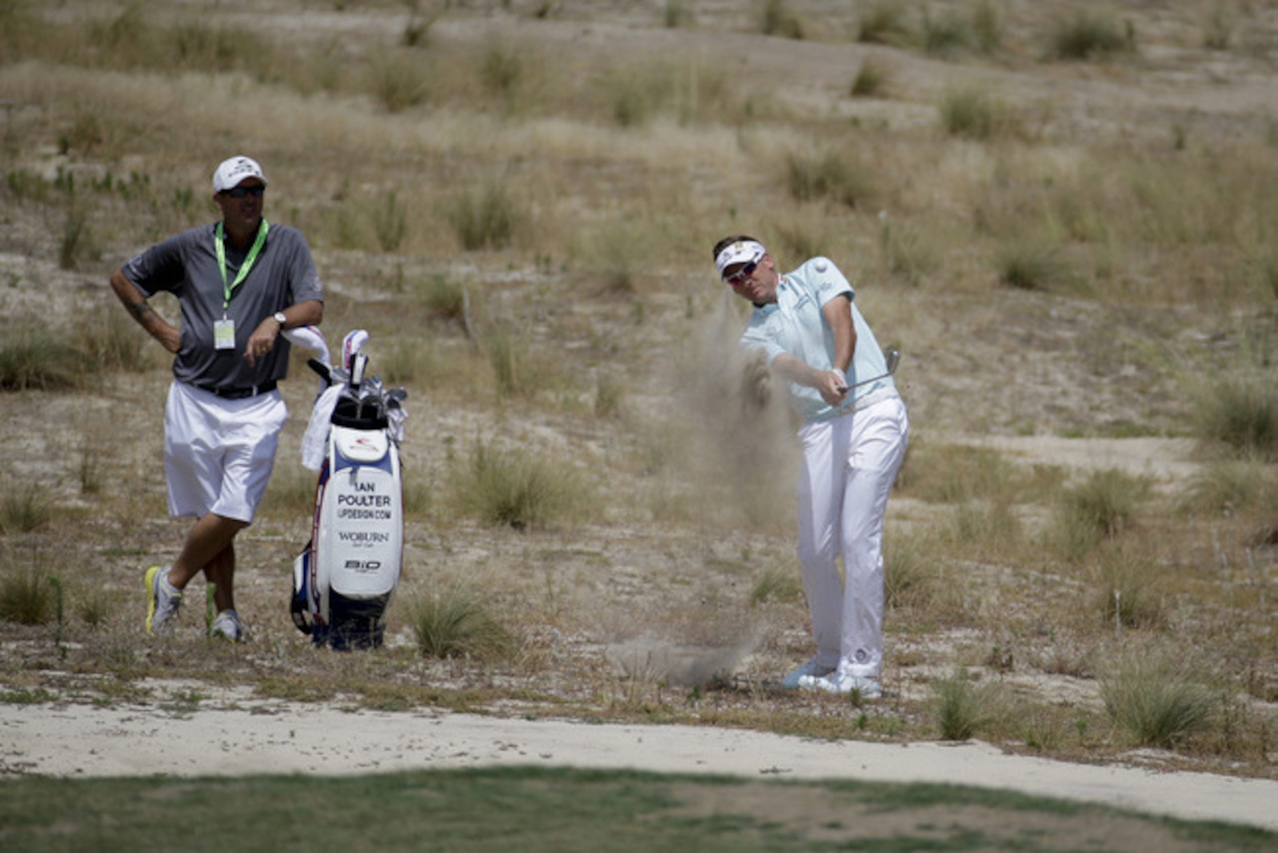 Ian Poulter hits out of a waste area at Pinehurst