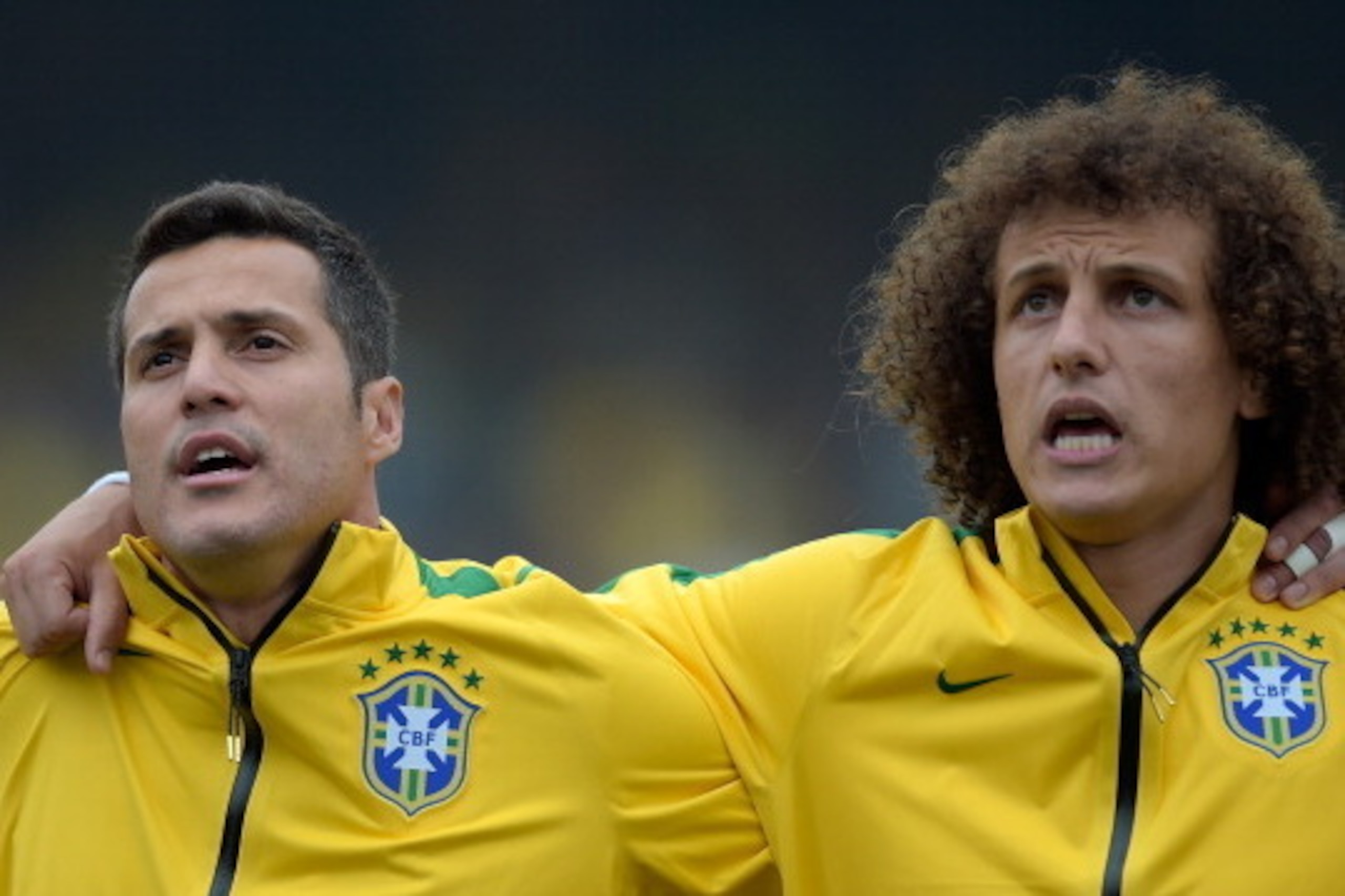 SAO PAULO, BRAZIL - JUNE 06: Goalkeeper Julio Cesar and David Luiz of Brazil sing the anthem before the International Friendly Match between Brazil and Serbia at Morumbi Stadium on June 06, 2014 in Sao Paulo, Brazil.  (Photo by Buda Mendes/Getty Images)