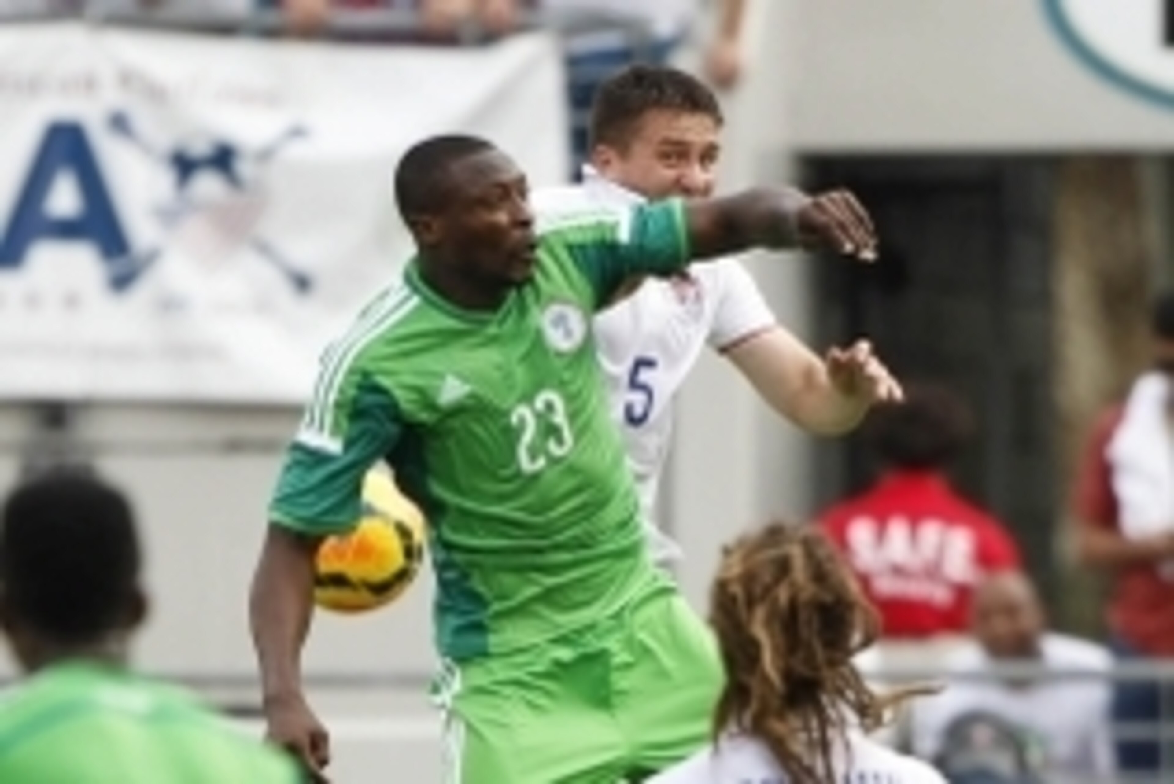 Jun 7, 2014; Jacksonville, FL, USA; Nigeria forward Shola Ameobi (23) and United States defender Matt Besler (5) miss the header during the first half at EverBank Field. Mandatory Credit: Kim Klement-USA TODAY Sports